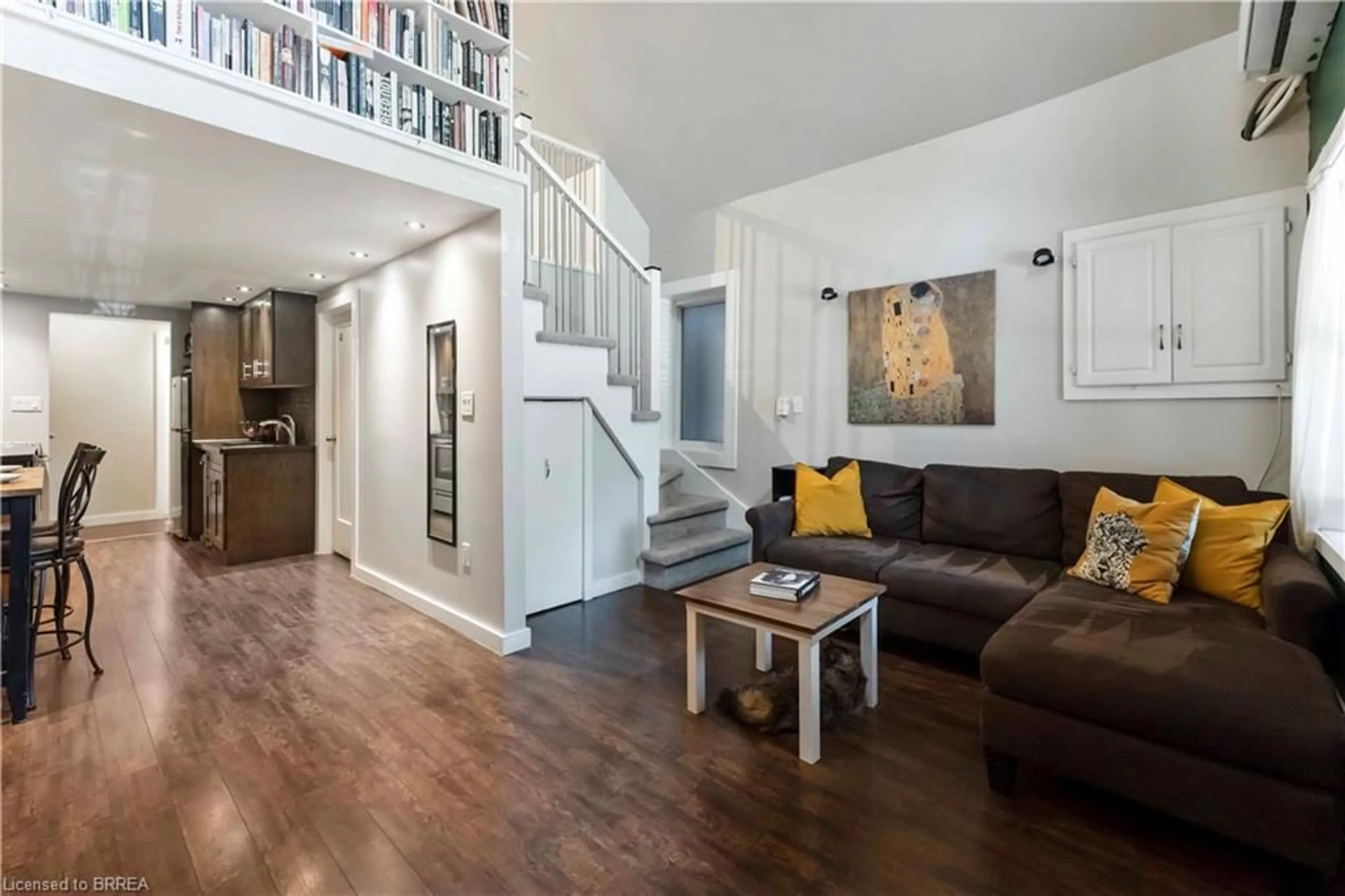 Living room with furniture, wood/laminate floor for 21 1/2 Albany Ave, Hamilton Ontario L8H 2H3