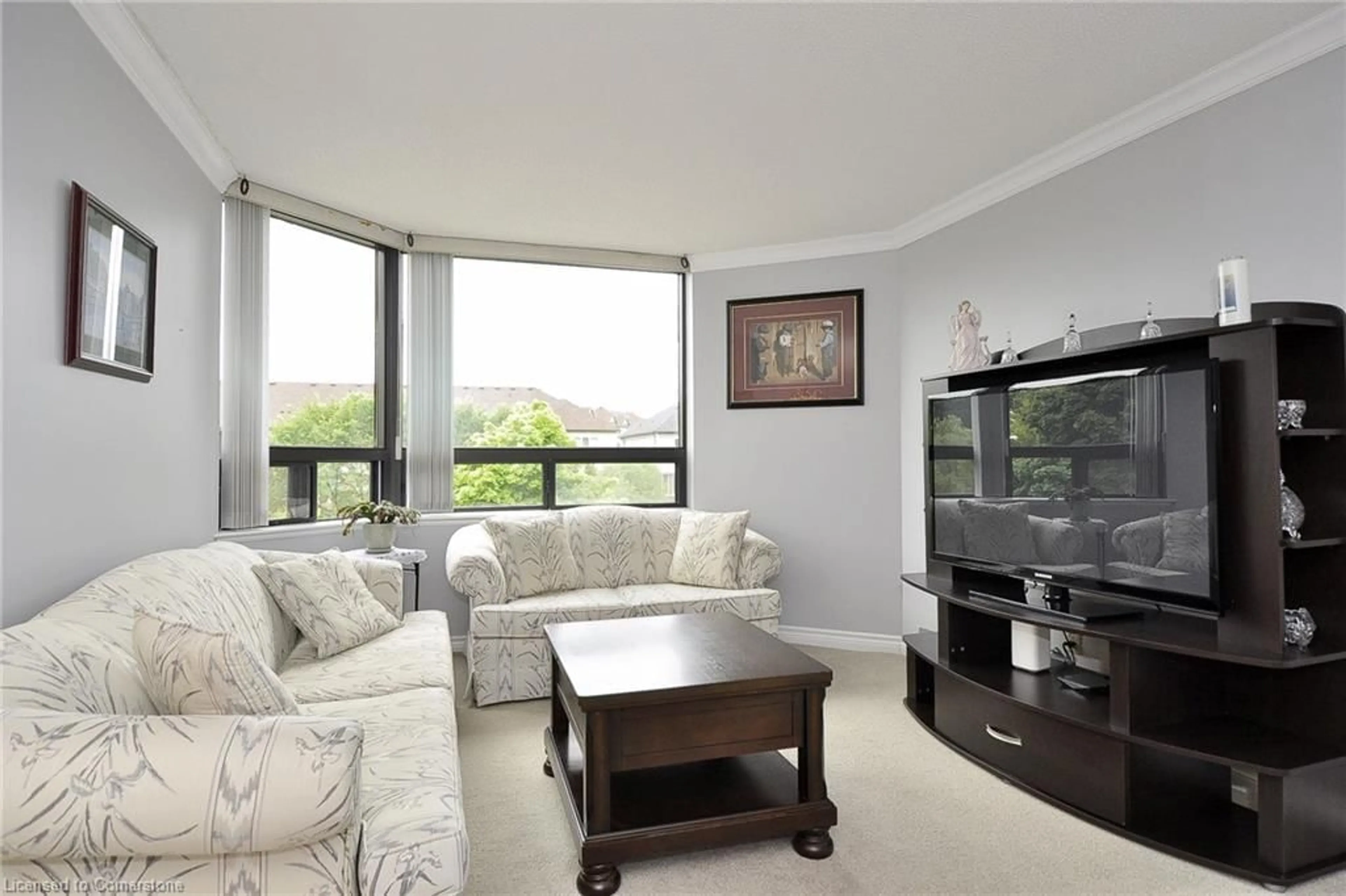 Living room with furniture, wood/laminate floor for 688 Preston Pky #306, Cambridge Ontario N3H 5K6