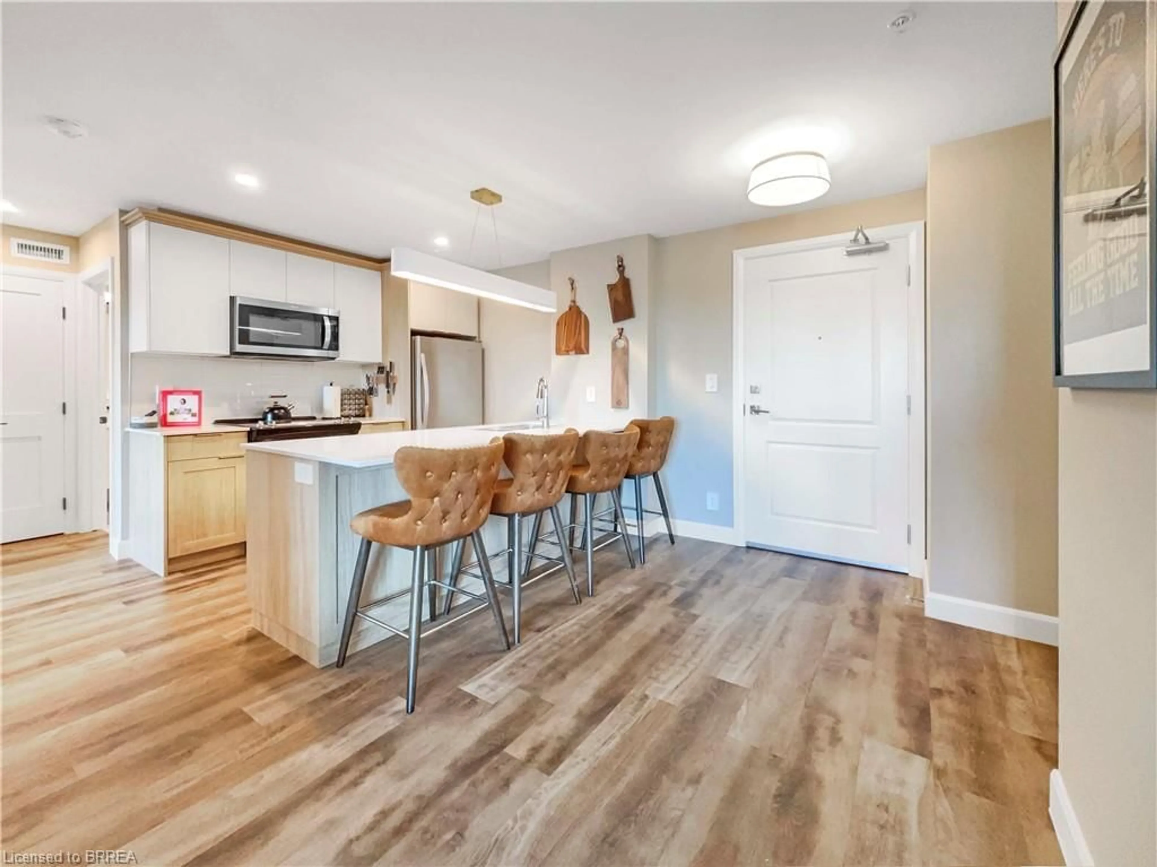 Open concept kitchen, wood/laminate floor for 34 Norman St #407, Brantford Ontario N3R 2Y1