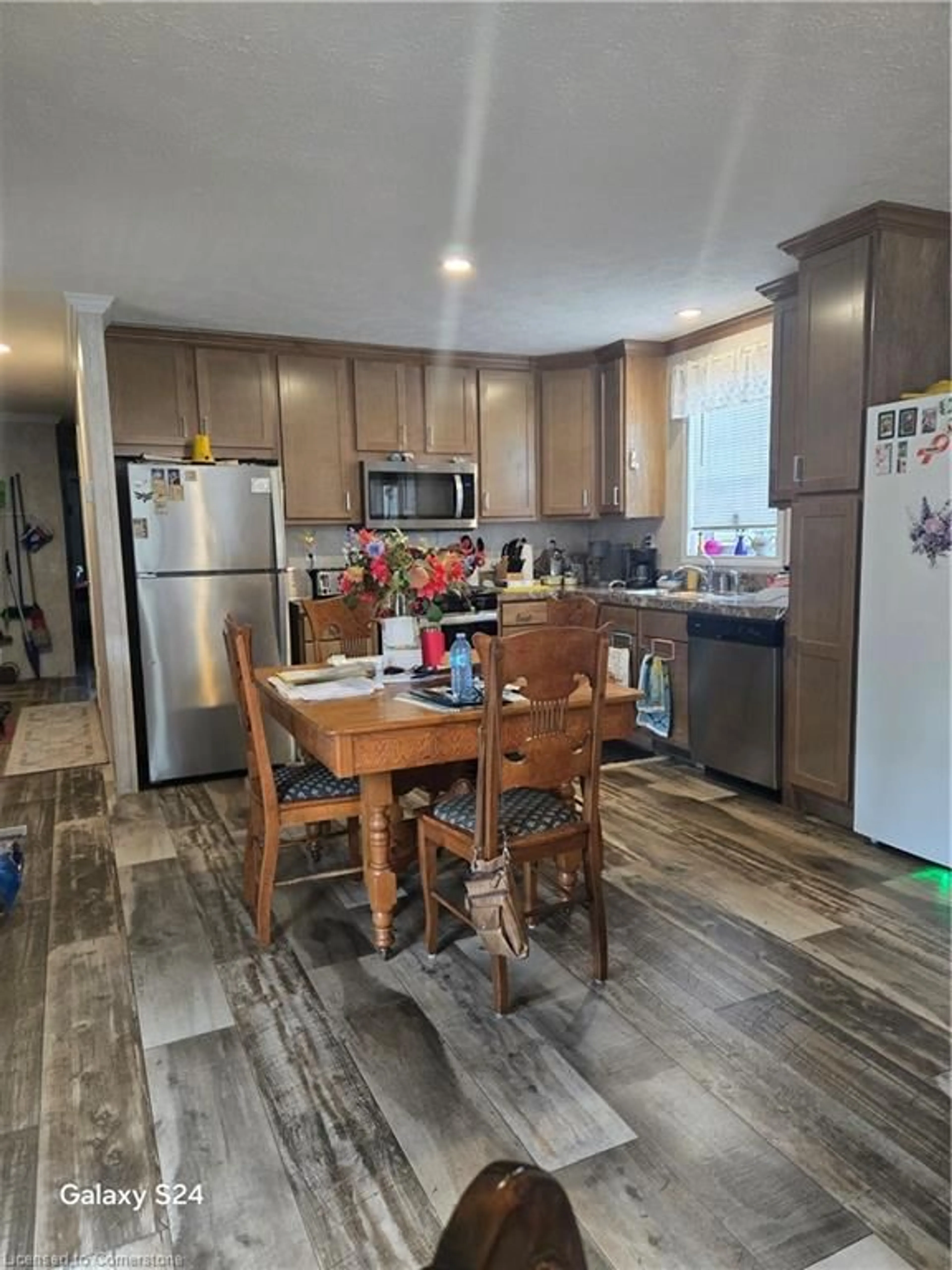 Open concept kitchen, wood/laminate floor for 99 Fourth Concession Rd #515 Roselawn, Burford Ontario N0E 1A0