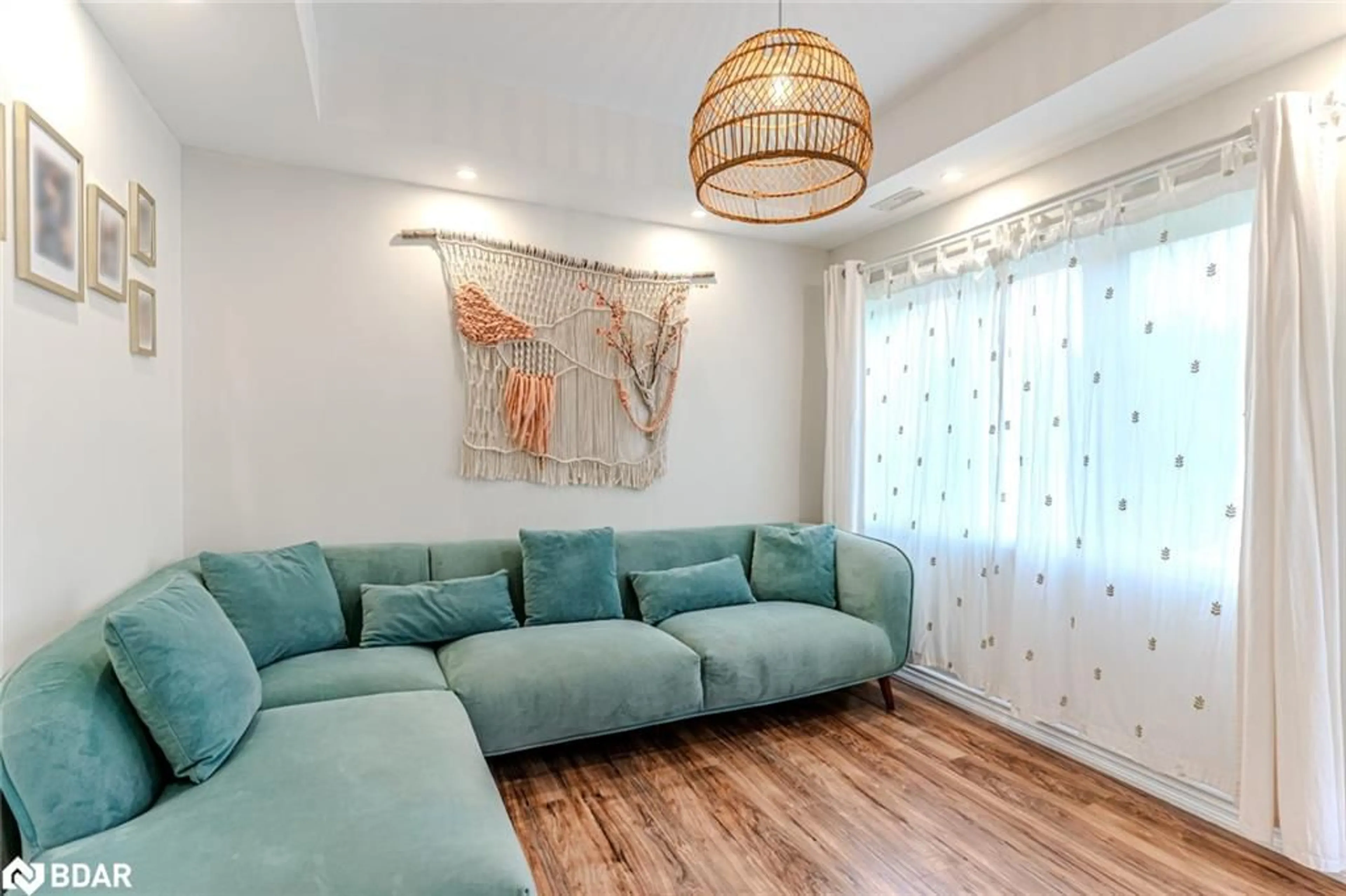 Living room with furniture, wood/laminate floor for 1011 Gilmore Ave, Lefroy Ontario L0L 1W0