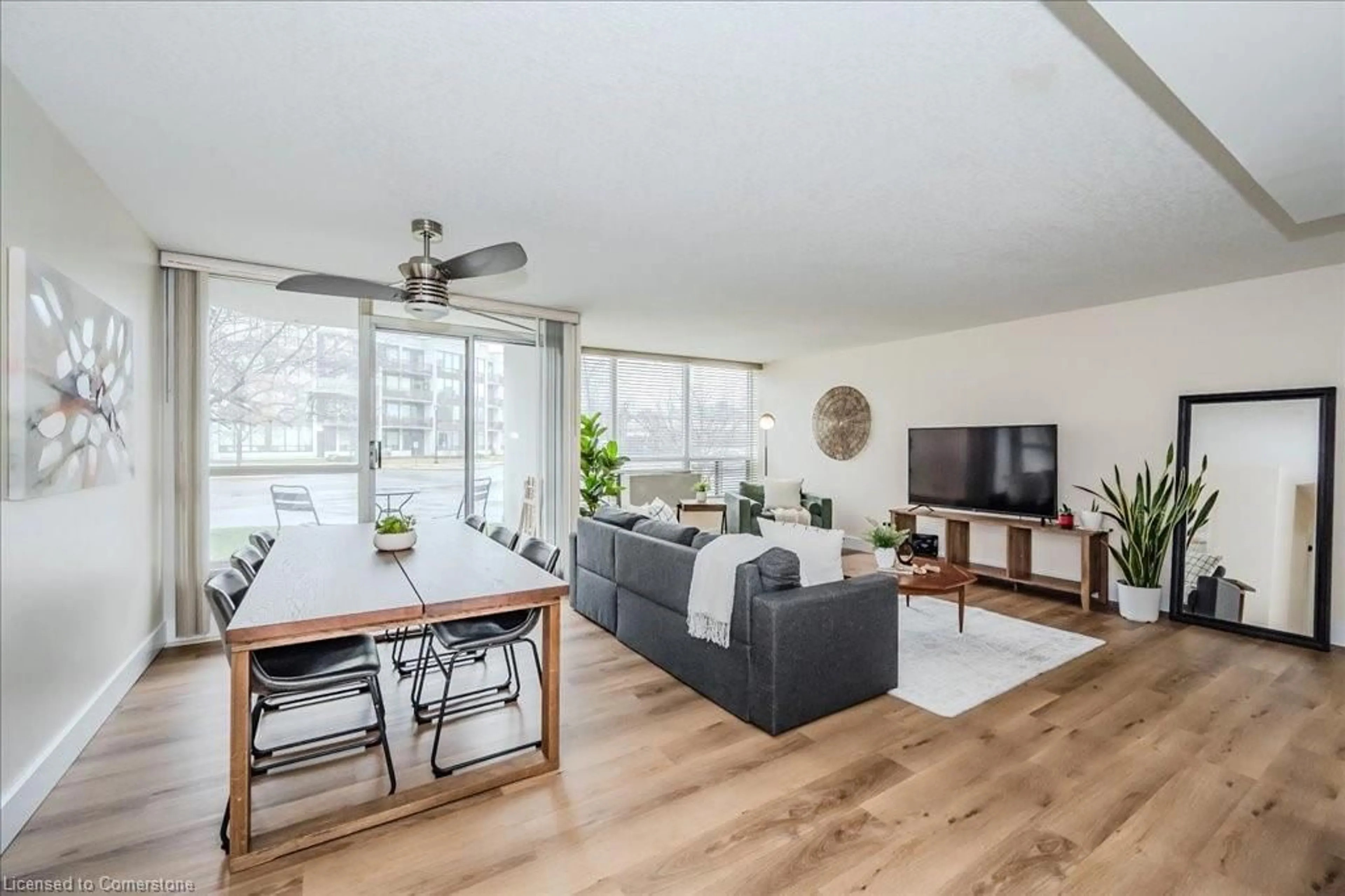 Living room with furniture, wood/laminate floor for 107 Bagot St #110, Guelph Ontario N1H 8H5