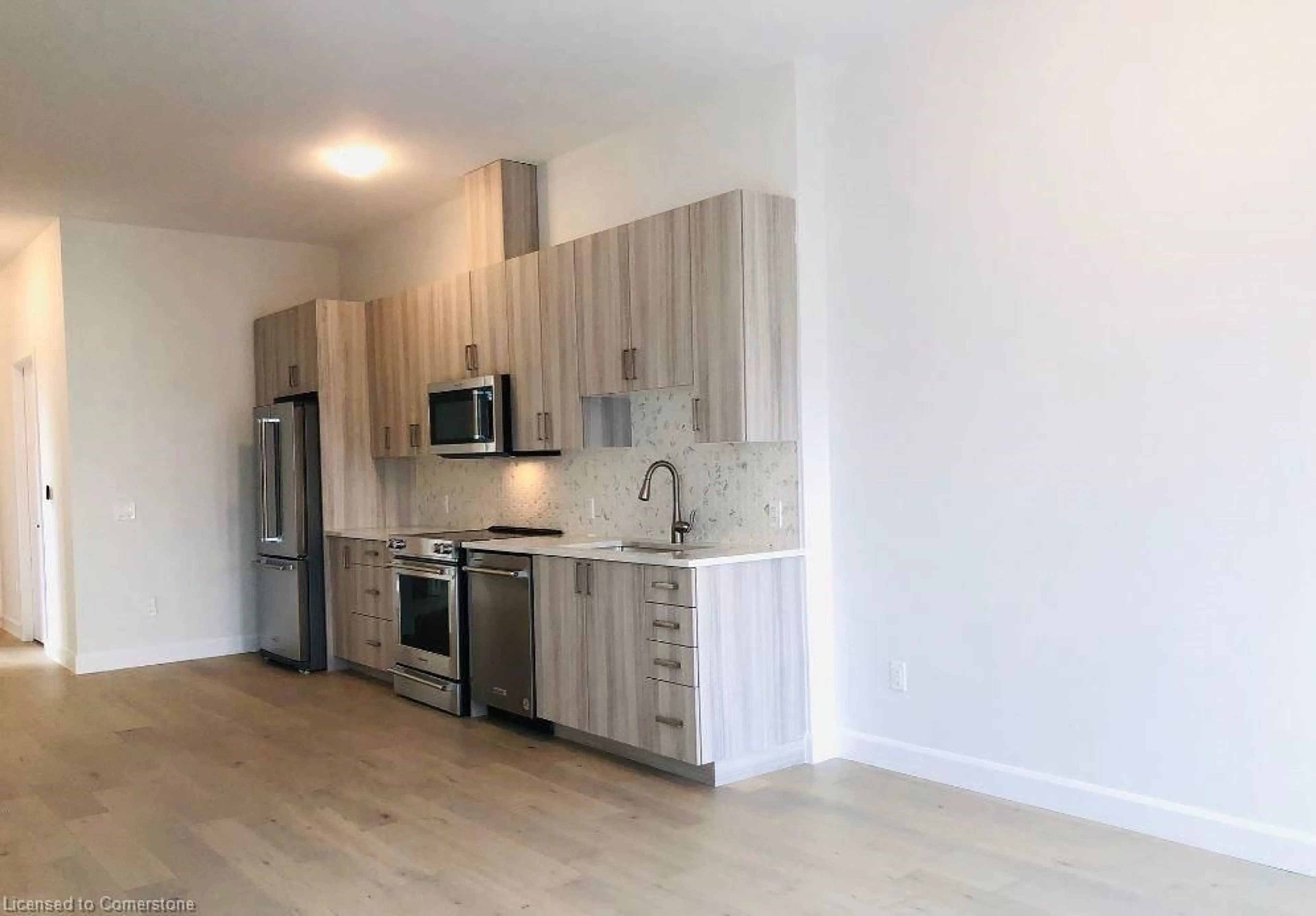 Open concept kitchen, wood/laminate floor for 51 David St #602, Kitchener Ontario N2G 1K1