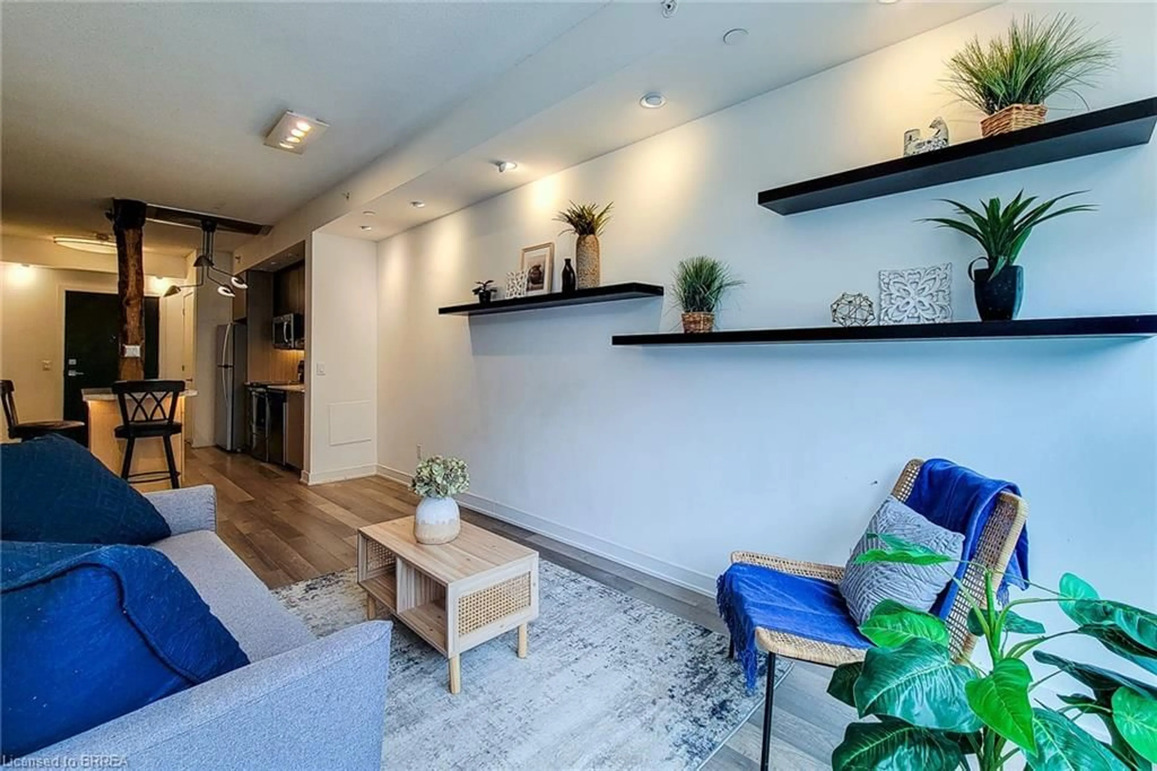 Living room with furniture, wood/laminate floor for 5240 Dundas St #B215, Burlington Ontario L7L 0J6