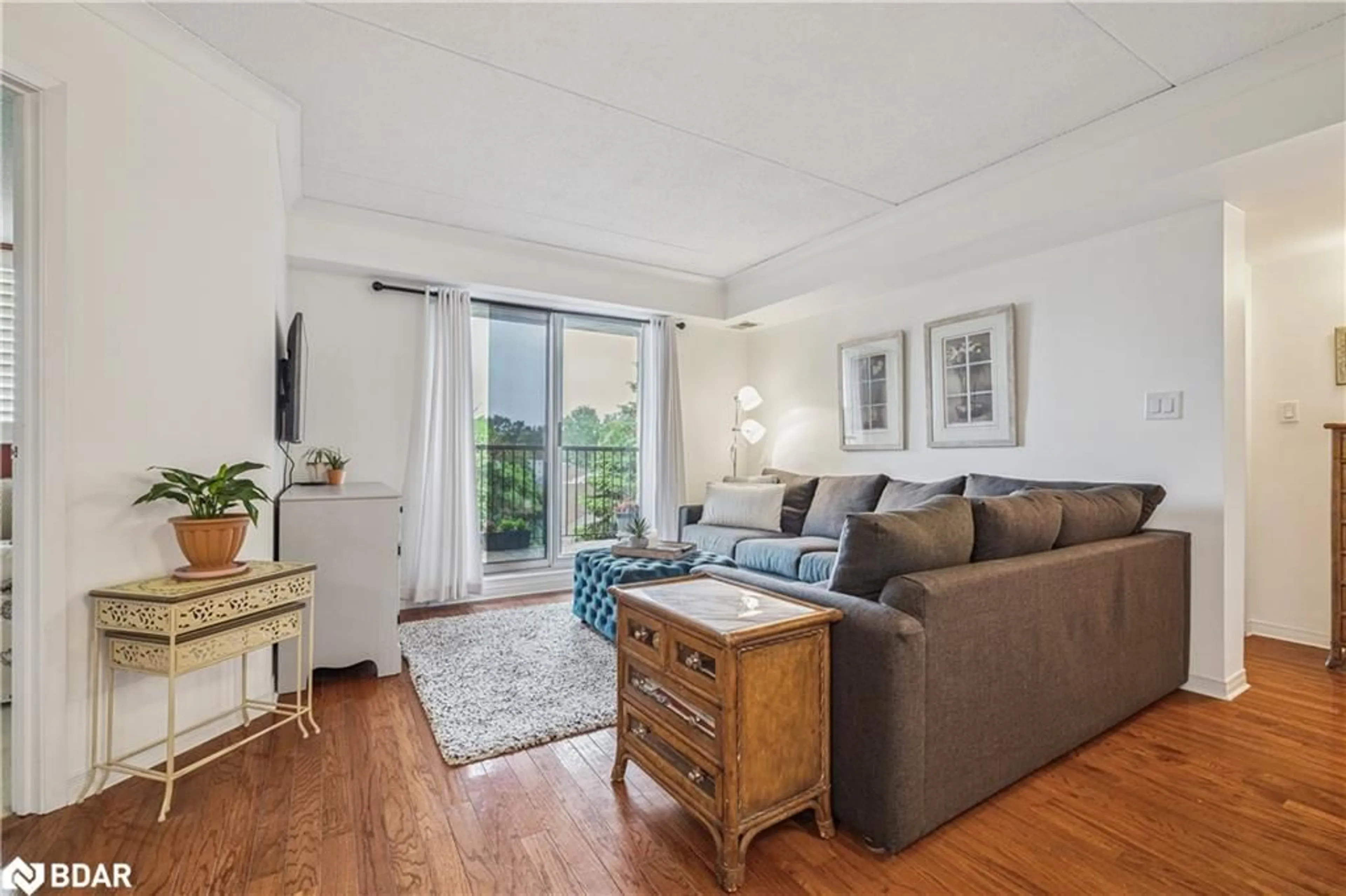 Living room with furniture, wood/laminate floor for 3499 Upper Middle Rd #406, Burlington Ontario L7M 4M7