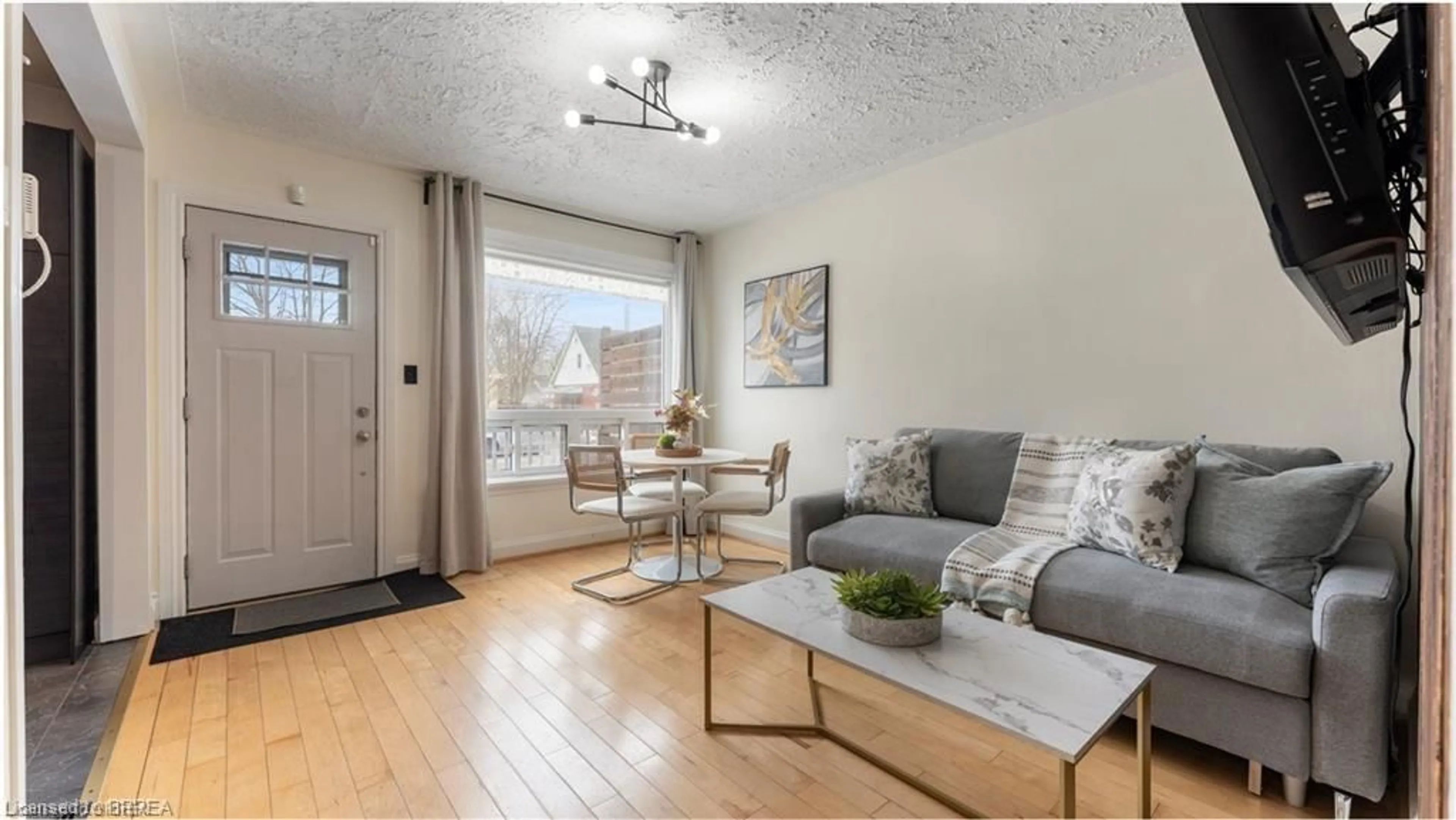 Living room with furniture, wood/laminate floor for 69 Lyons Ave, Brantford Ontario N3R 4R2