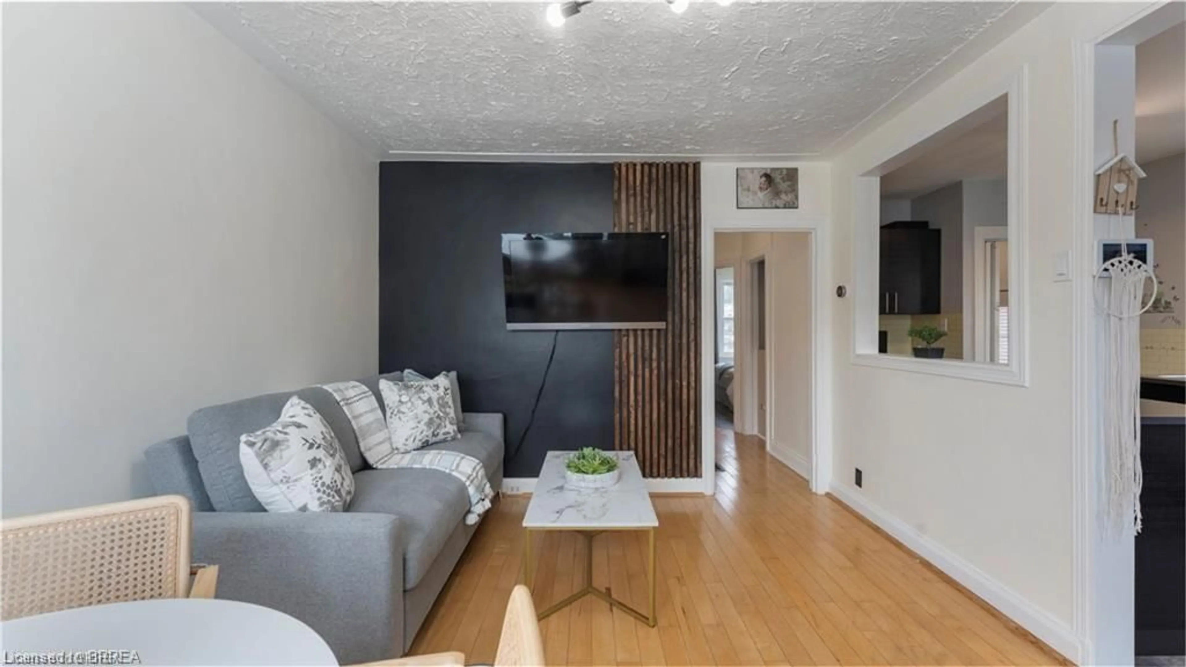 Living room with furniture, wood/laminate floor for 69 Lyons Ave, Brantford Ontario N3R 4R2