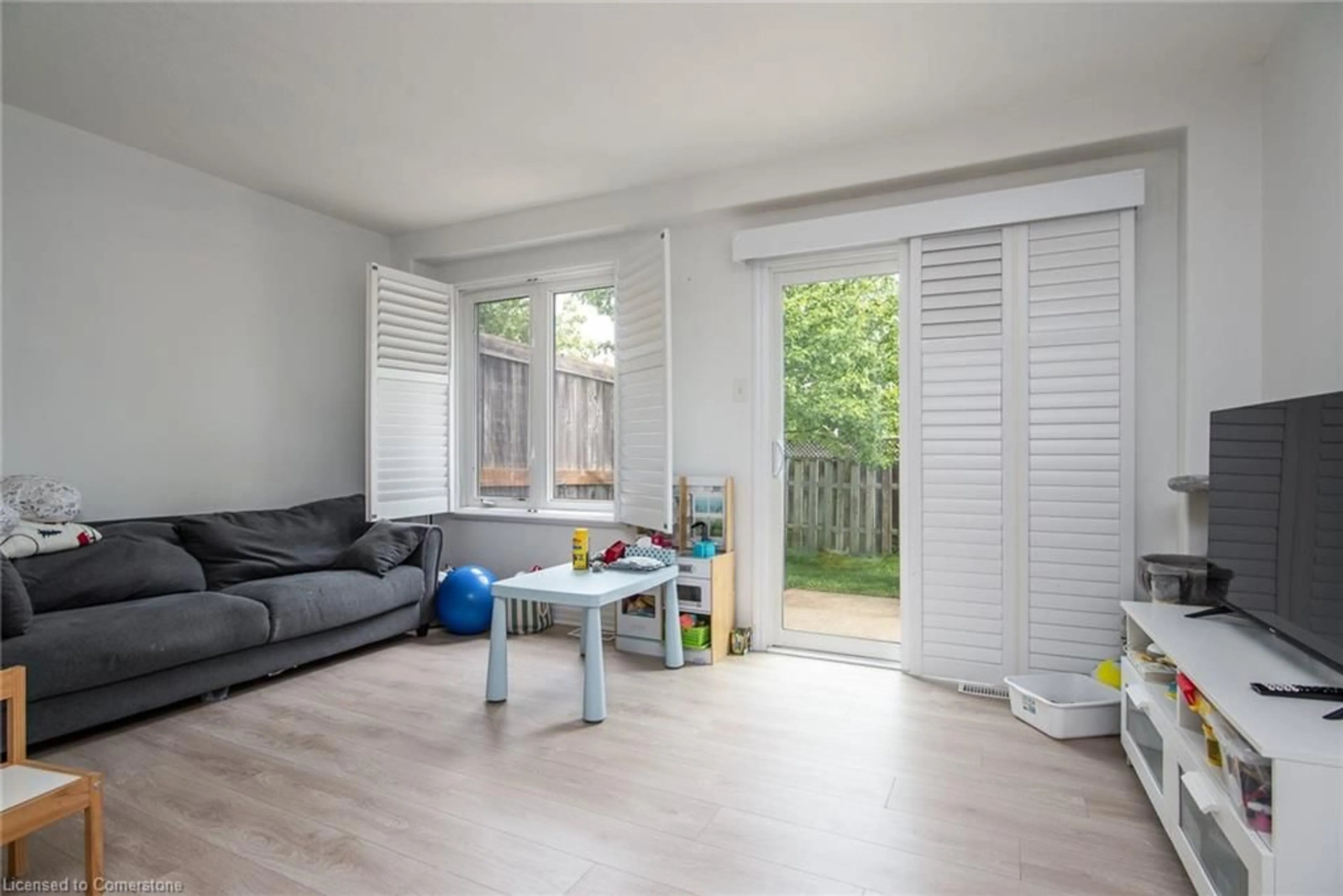 Living room with furniture, wood/laminate floor for 535 Windflower Cres #51, Kitchener Ontario N2E 4L7