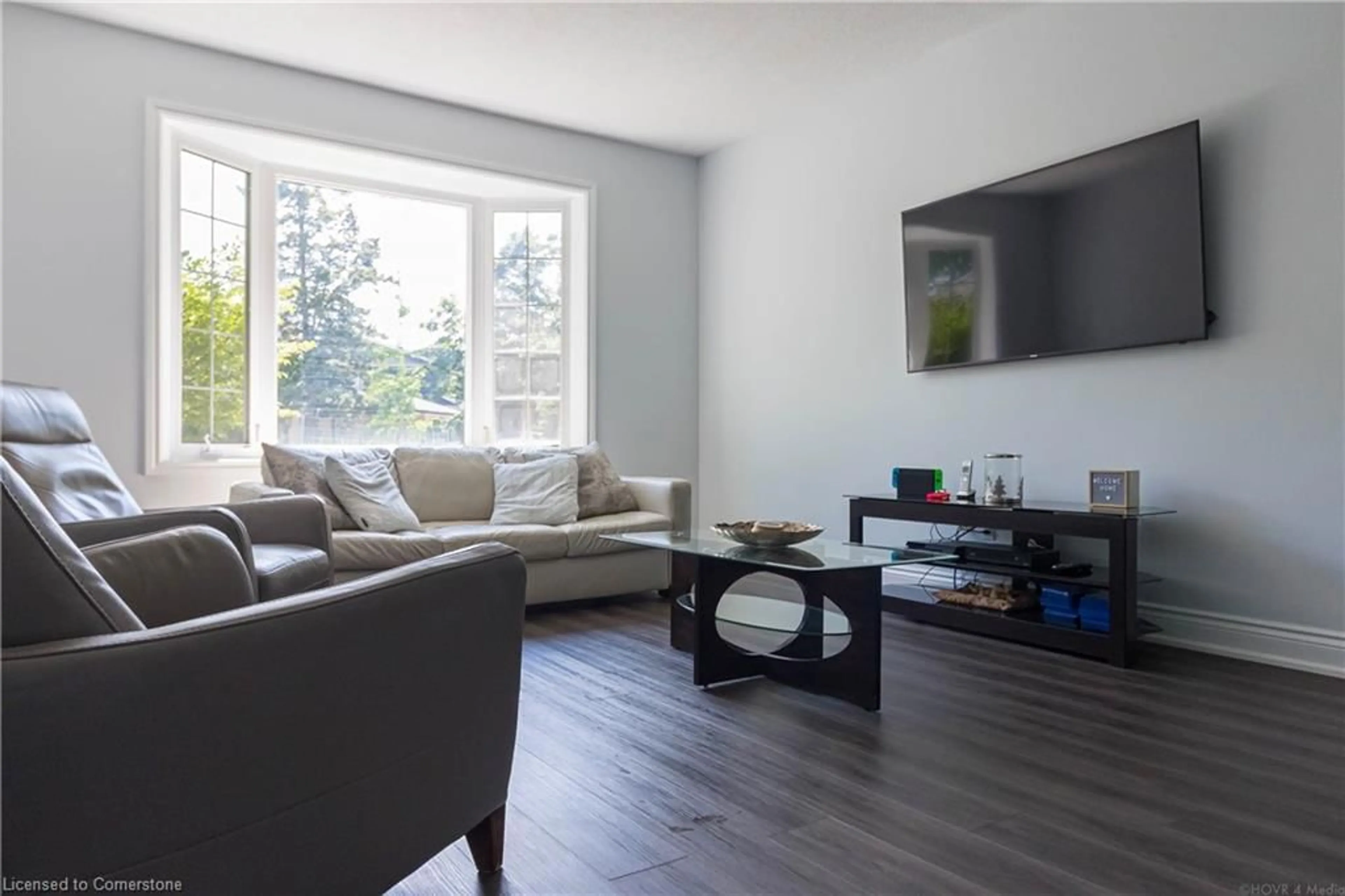Living room with furniture, wood/laminate floor for 2390 Sinclair Cir, Burlington Ontario L7P 3C3