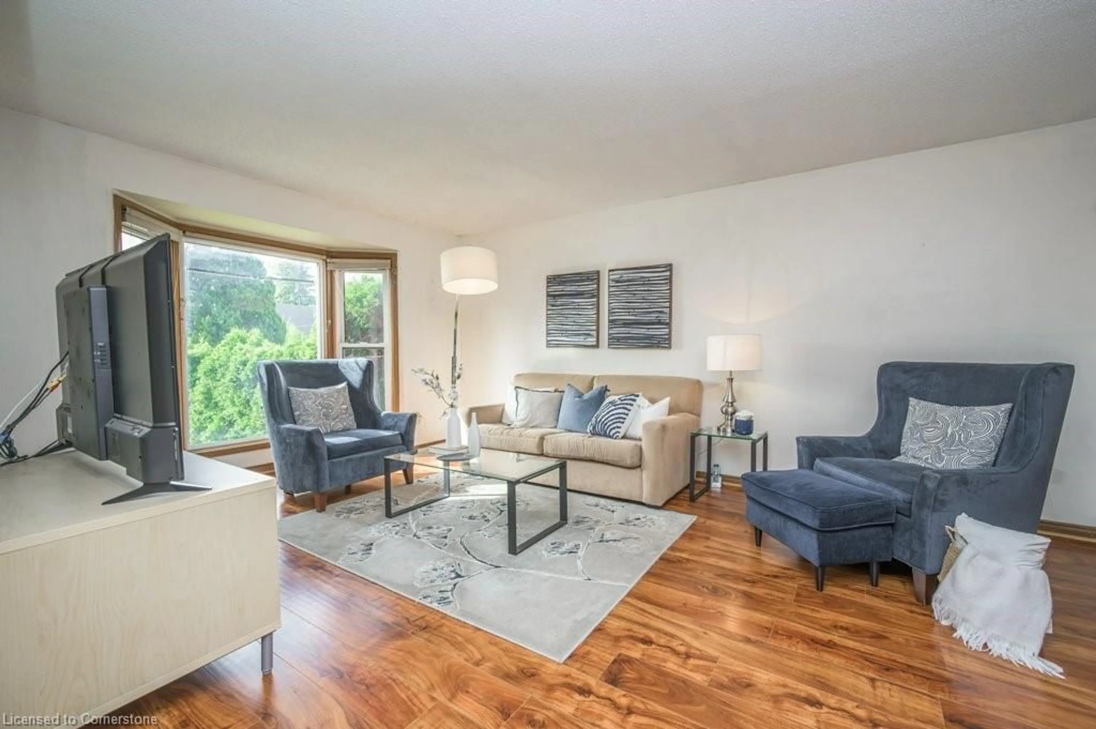 Living room with furniture, wood/laminate floor for 687 Penny Lane, Burlington Ontario L7T 4H9