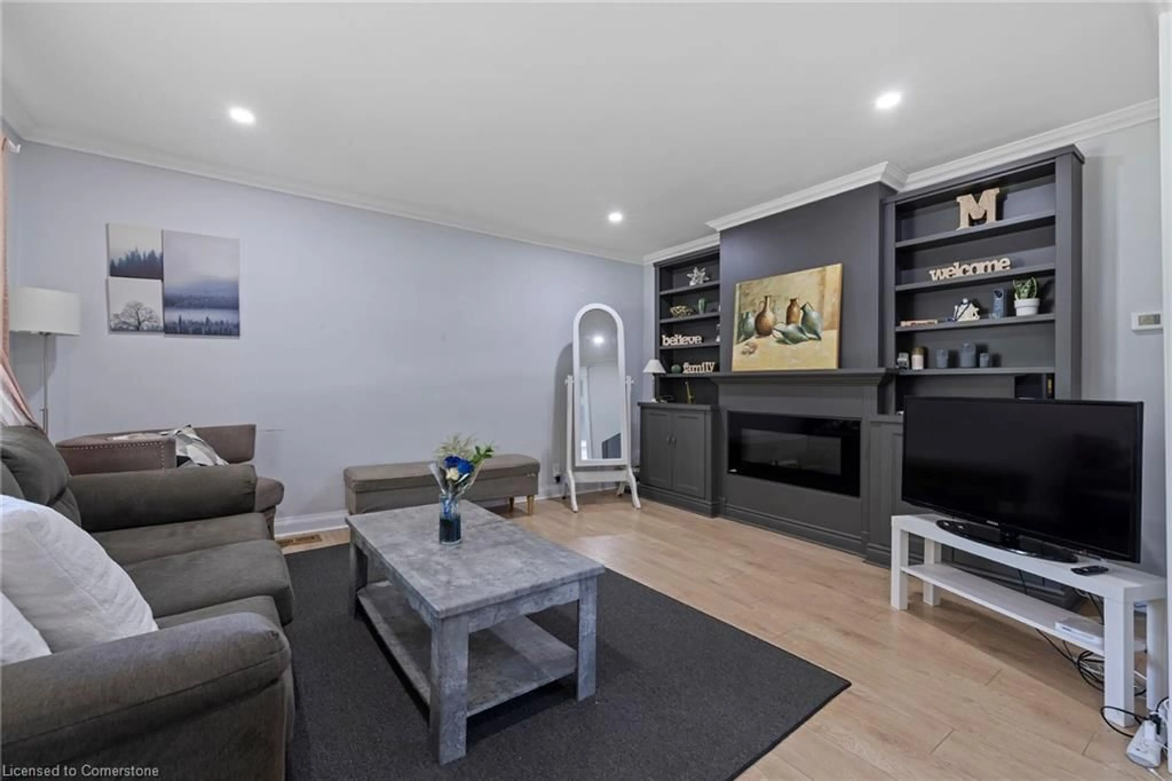 Living room with furniture, wood/laminate floor for 6568 Ralph Ave, Niagara Falls Ontario L2G 4H6
