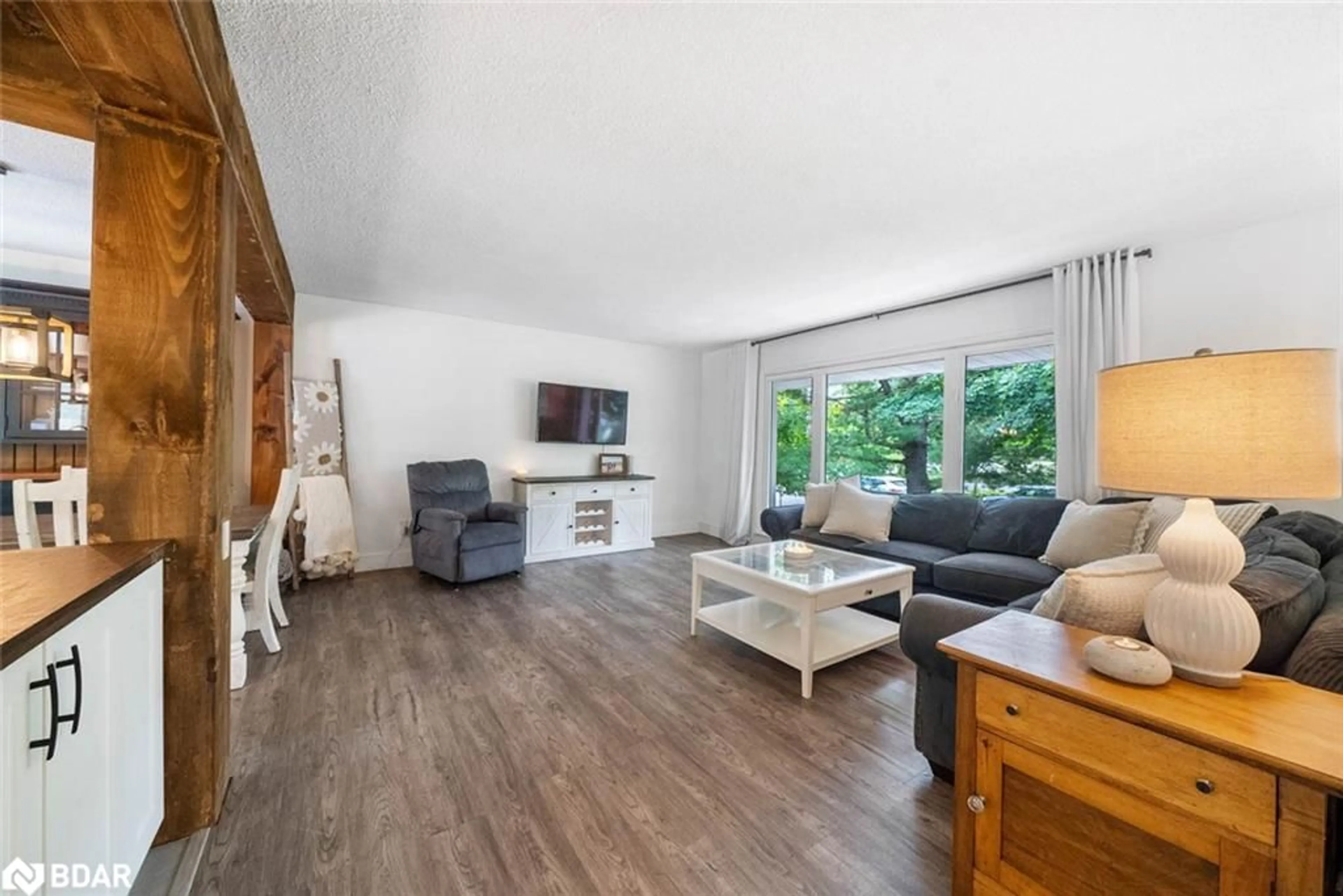 Living room with furniture, wood/laminate floor for 2 Noraline Ave, Midhurst Ontario L0L 1X1