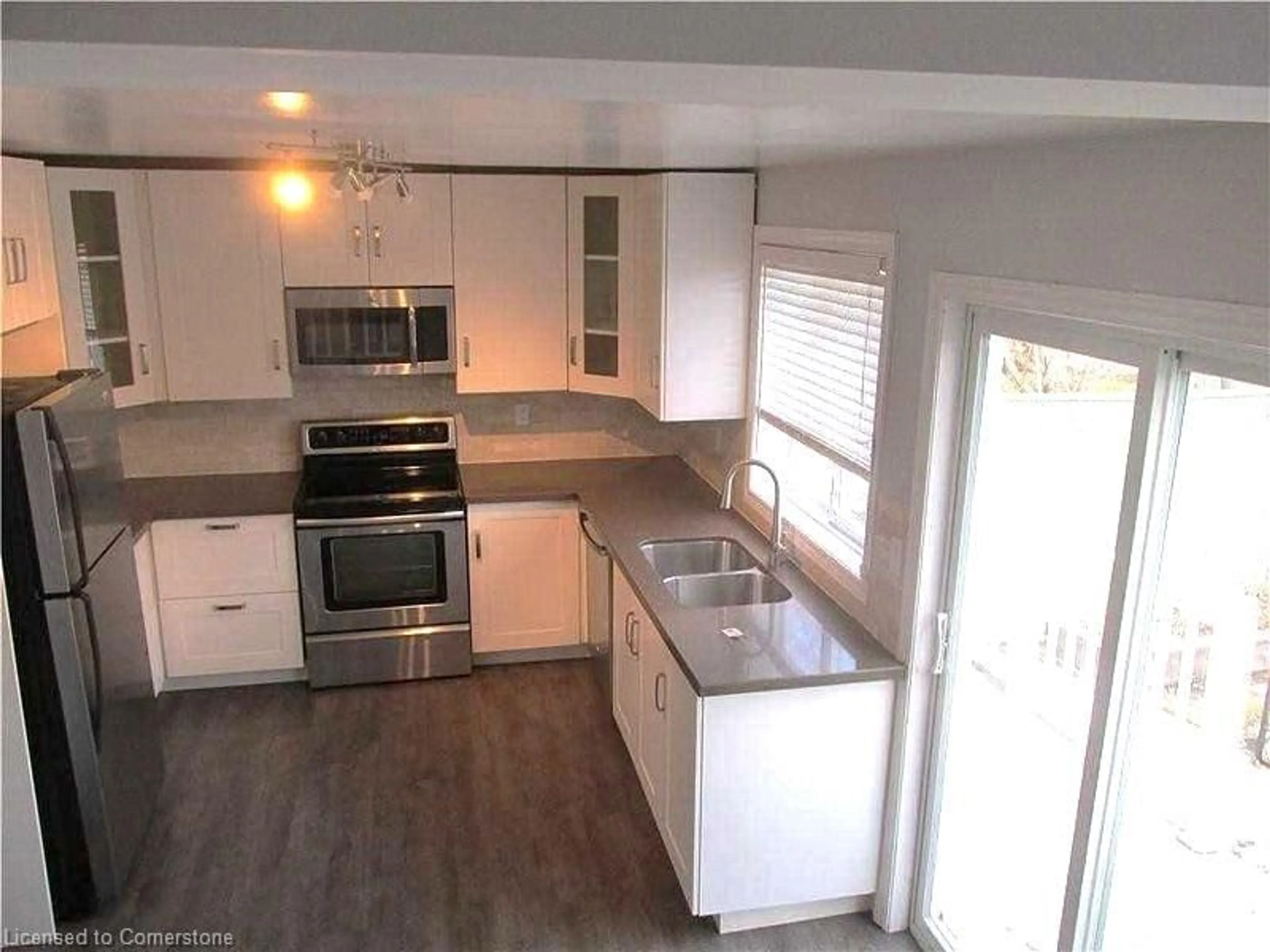 Open concept kitchen, wood/laminate floor for 136 Robins Ave, Hamilton Ontario L8H 4N8