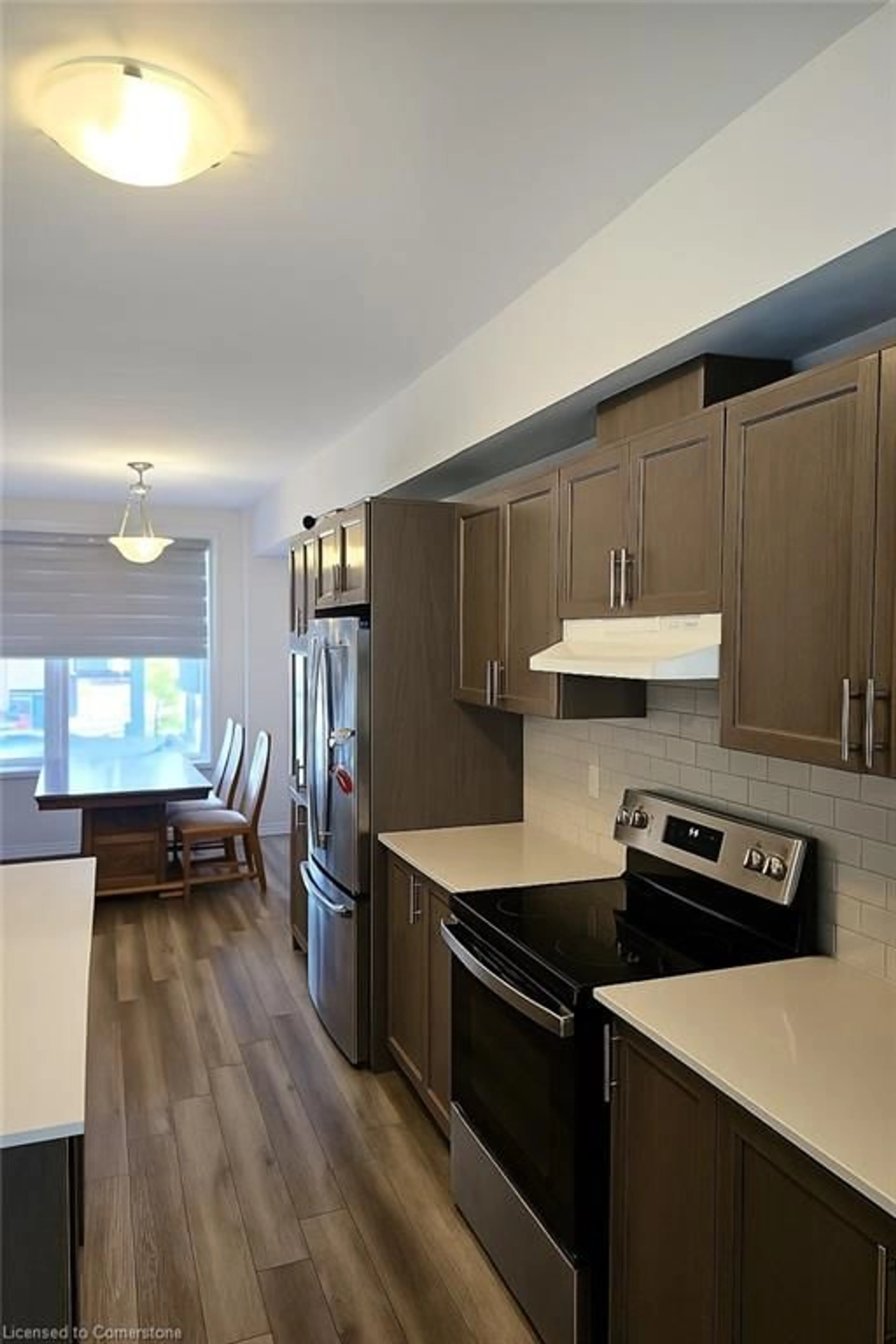 Open concept kitchen, wood/laminate floor for 290 Equestrian Way #58, Cambridge Ontario N3E 0E7