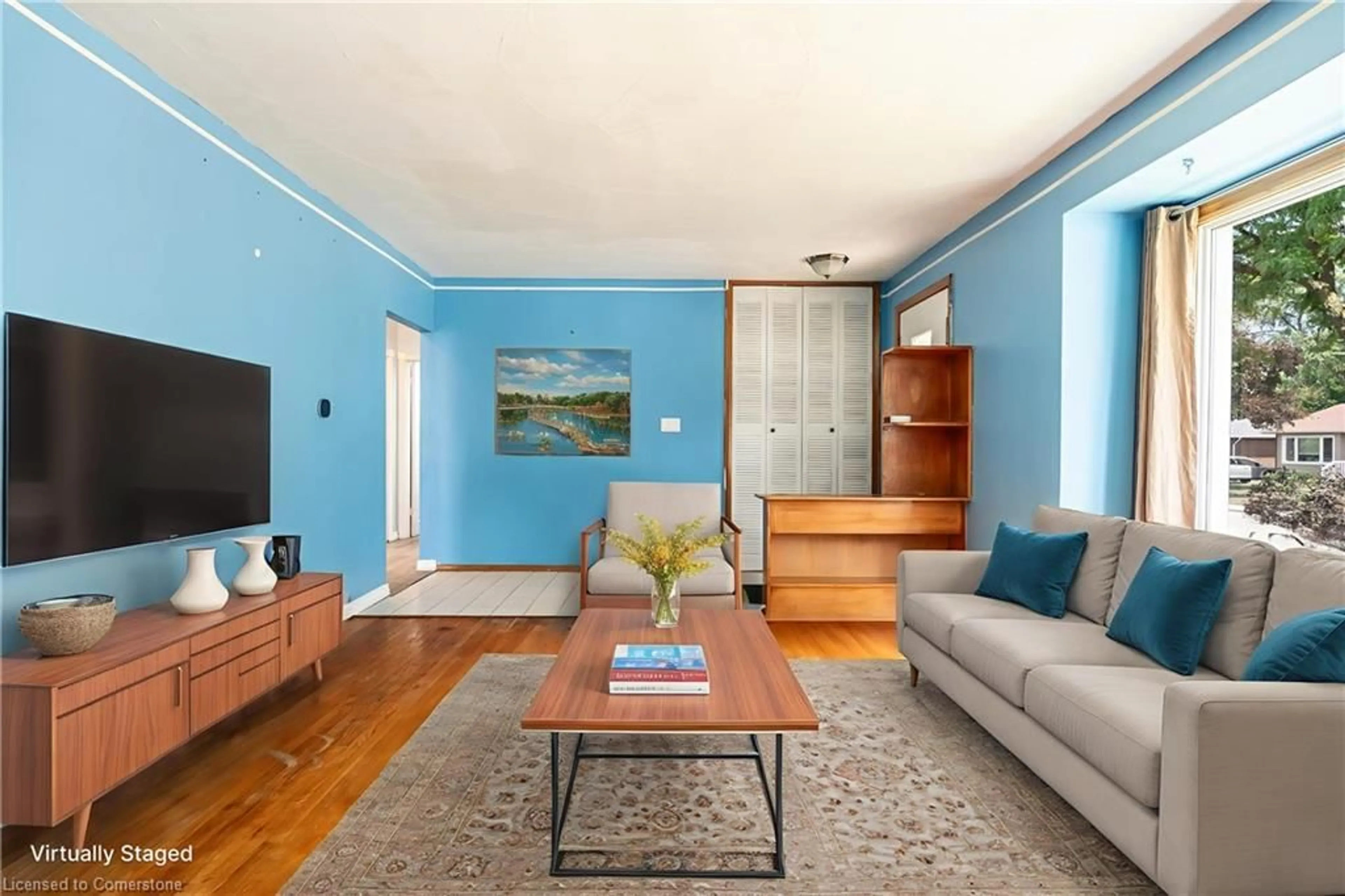 Living room with furniture, wood/laminate floor for 38 Goldfinch Rd, Hamilton Ontario L9A 3W7