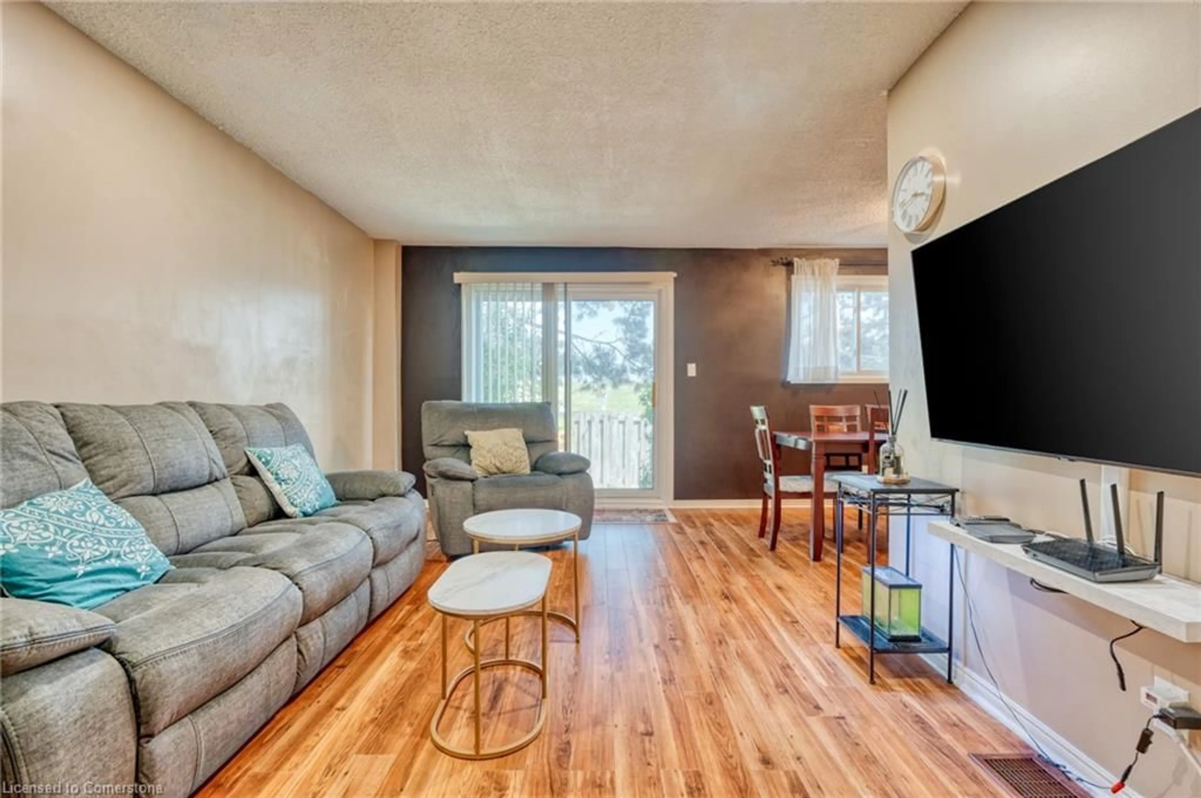 Living room with furniture, wood/laminate floor for 1440 Garth St #55, Hamilton Ontario L9B 1R6