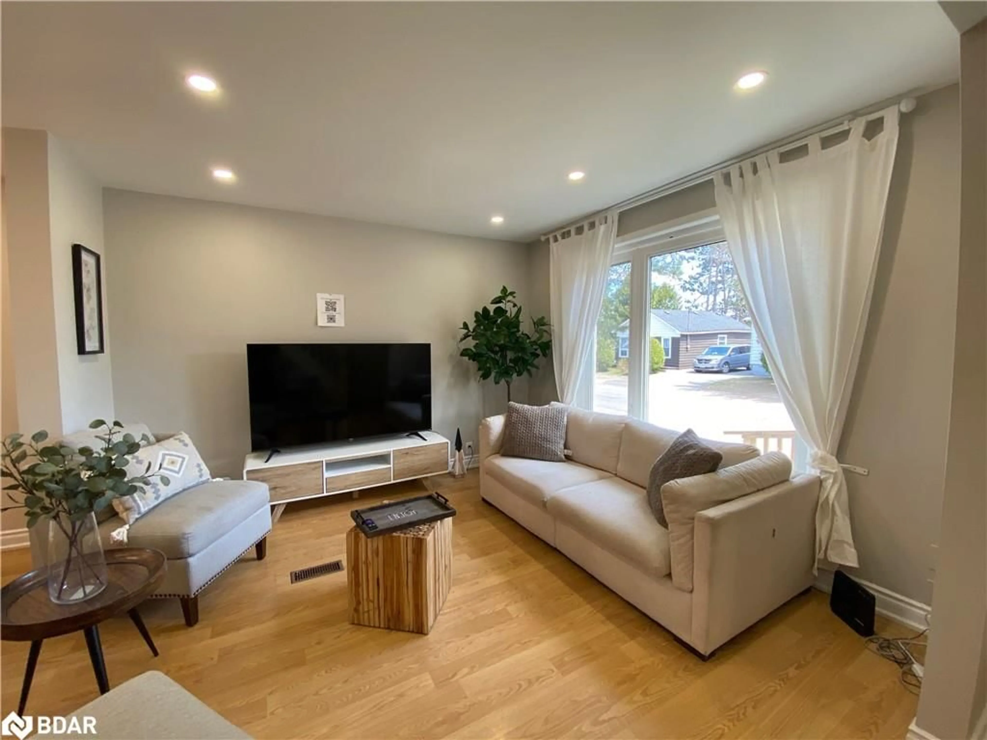 Living room with furniture, wood/laminate floor for 62 Ottawa St, Whitney Ontario K0J 2M0
