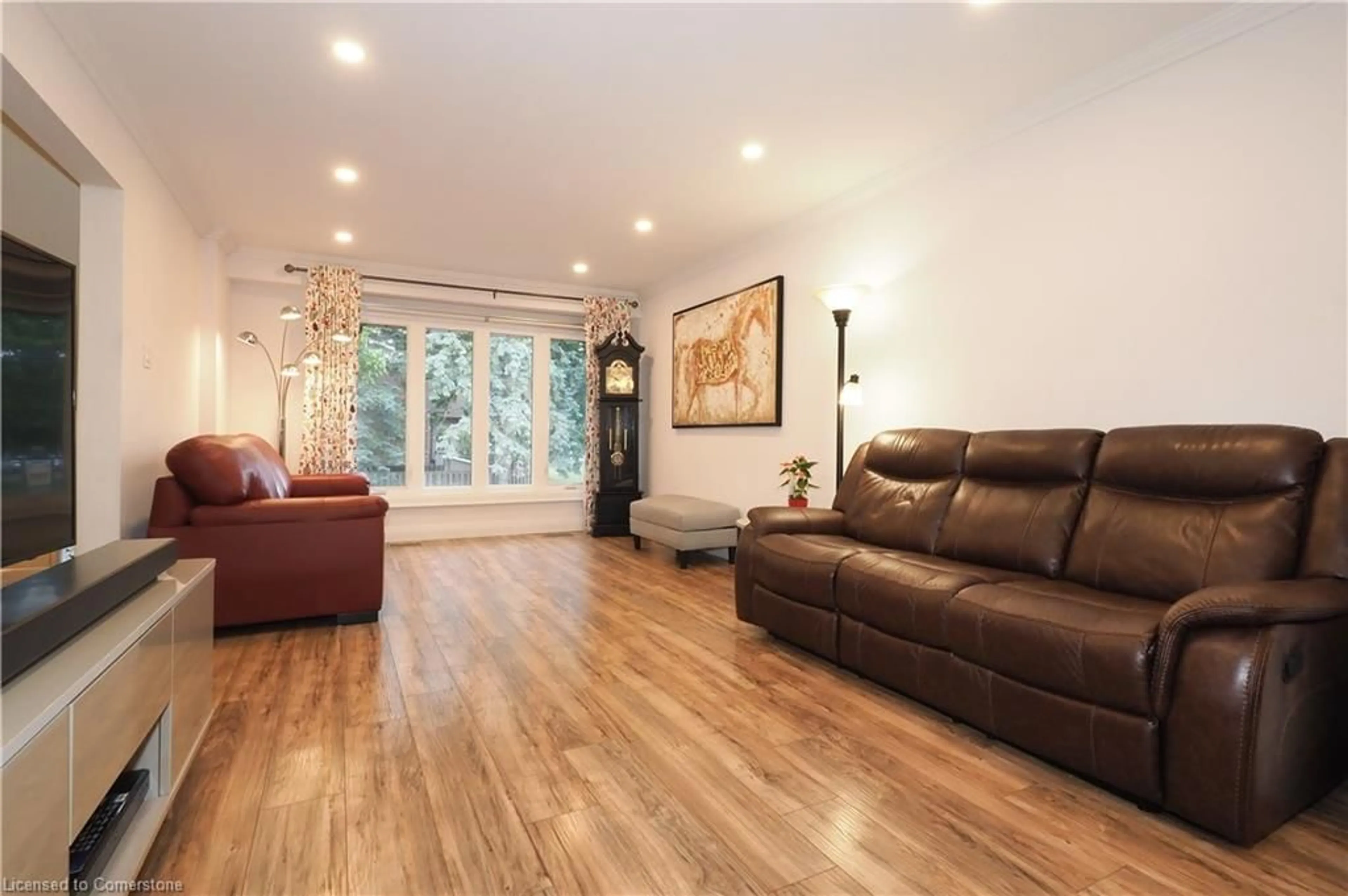 Living room with furniture, wood/laminate floor for 49 Cedarwoods Cres #50, Kitchener Ontario N2C 2L1