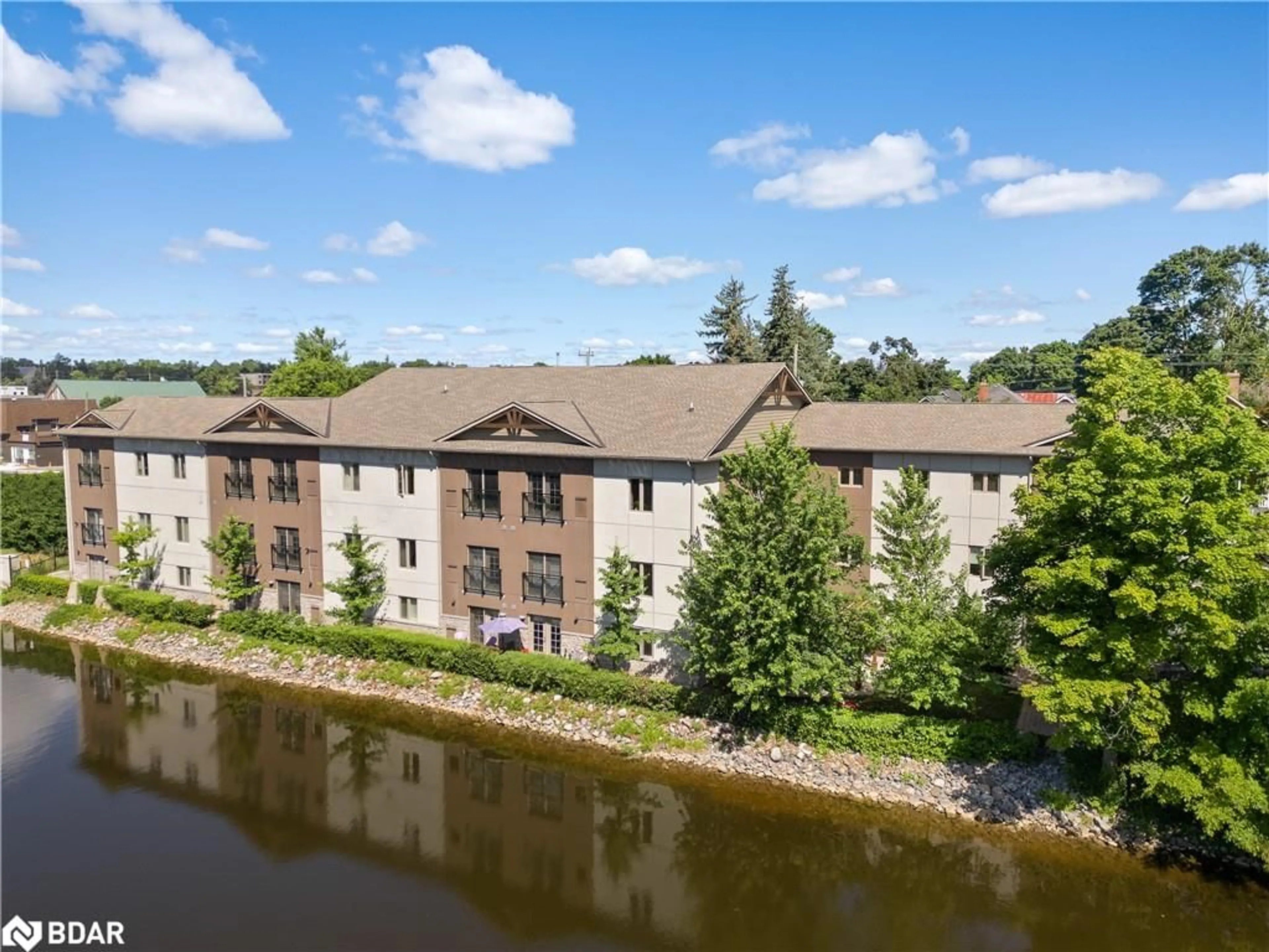 A pic from outside/outdoor area/front of a property/back of a property/a pic from drone, water/lake/river/ocean view for 25 King St #102, Lindsay Ontario K9V 1C4