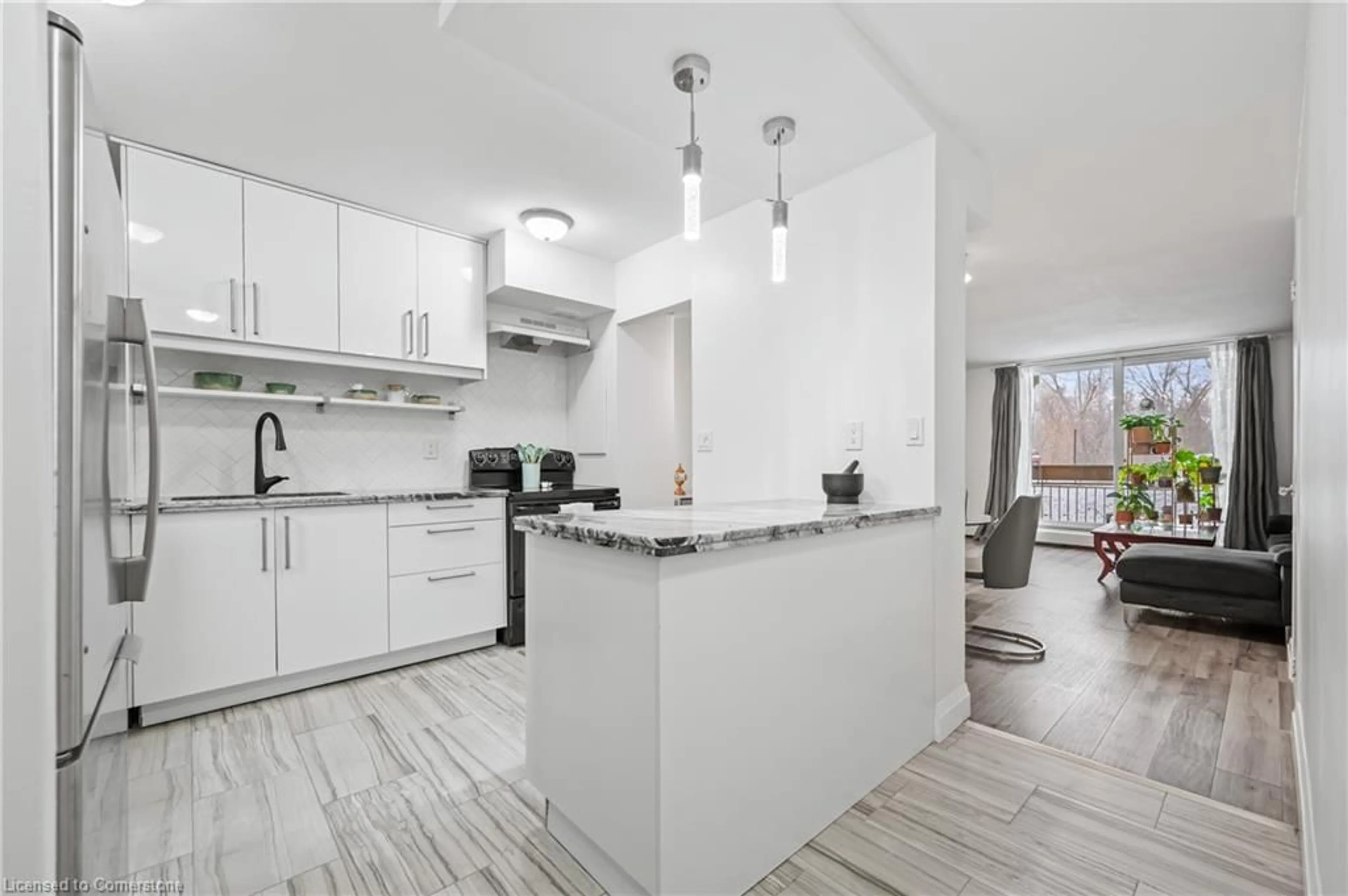 Open concept kitchen, ceramic/tile floor for 350 Quigley Rd #141, Hamilton Ontario L8K 5N2