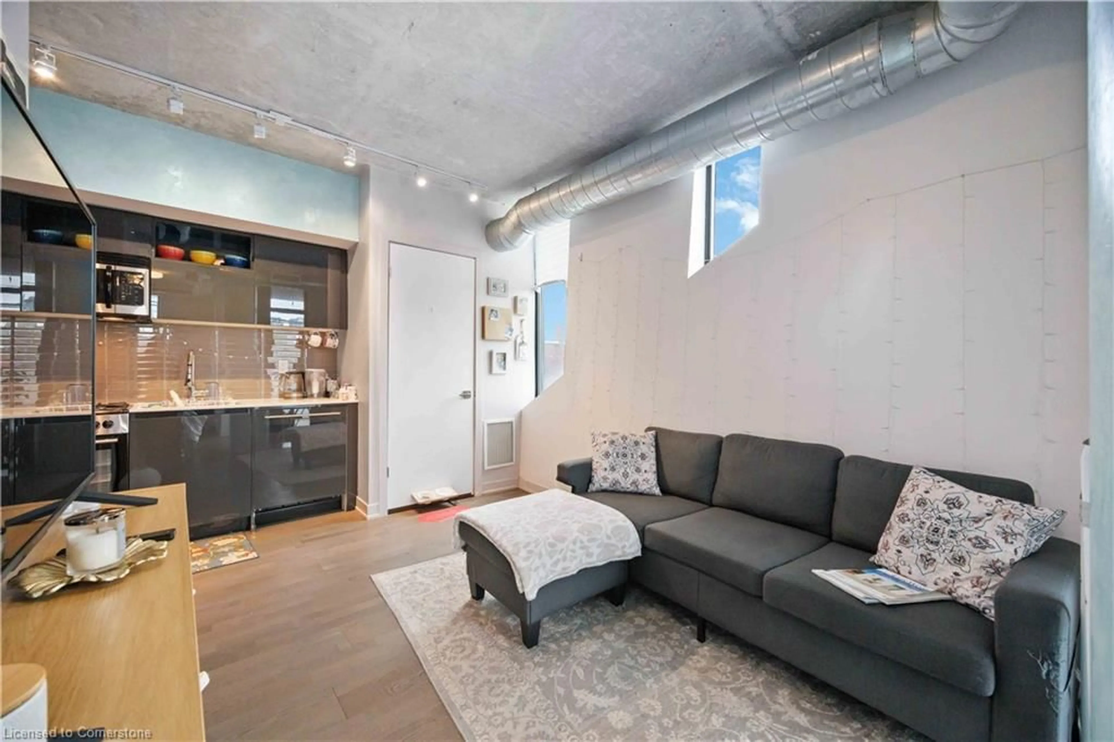 Living room with furniture, cement floor for 109 Wolseley St #204, Toronto Ontario M6J 1K1