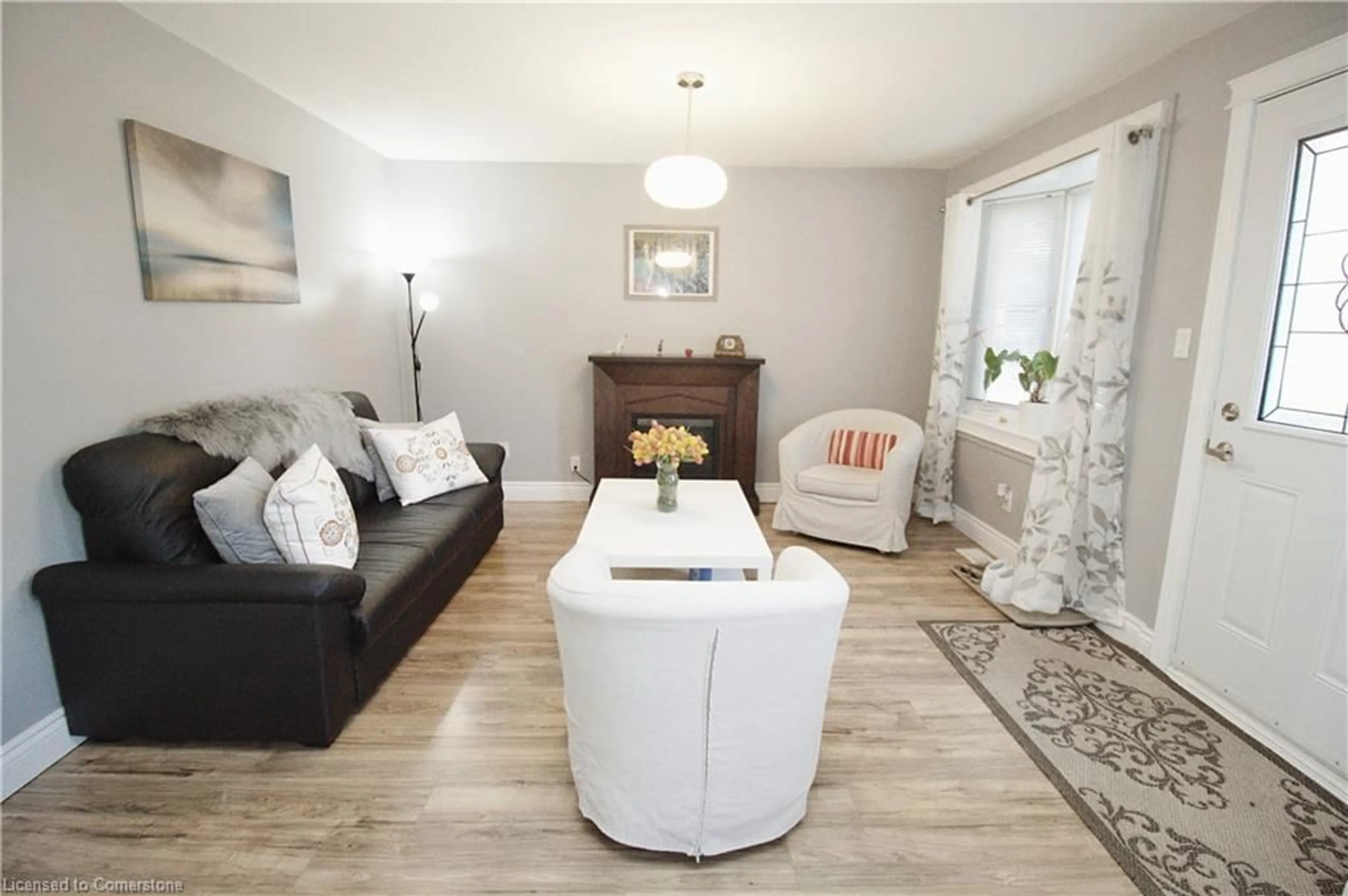 Living room with furniture, wood/laminate floor for 109 Warren Ave, Hamilton Ontario L9A 3C9