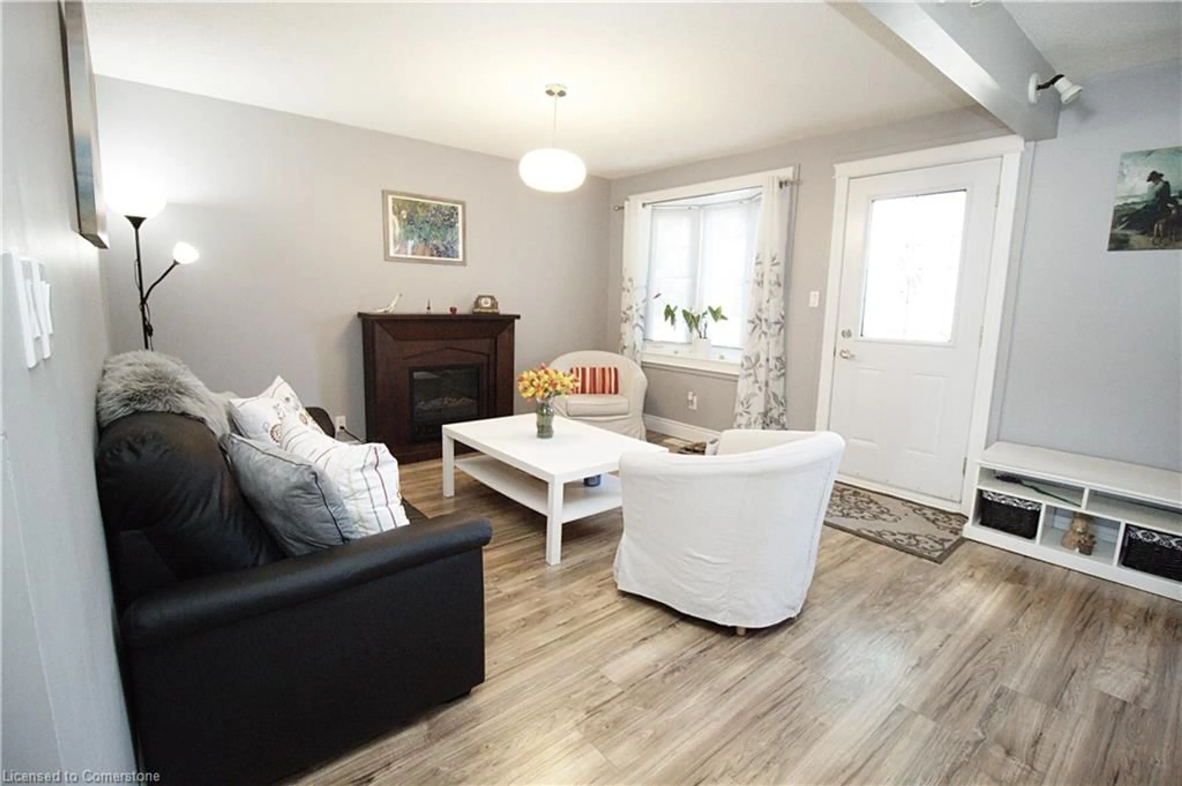 Living room with furniture, wood/laminate floor for 109 Warren Ave, Hamilton Ontario L9A 3C9