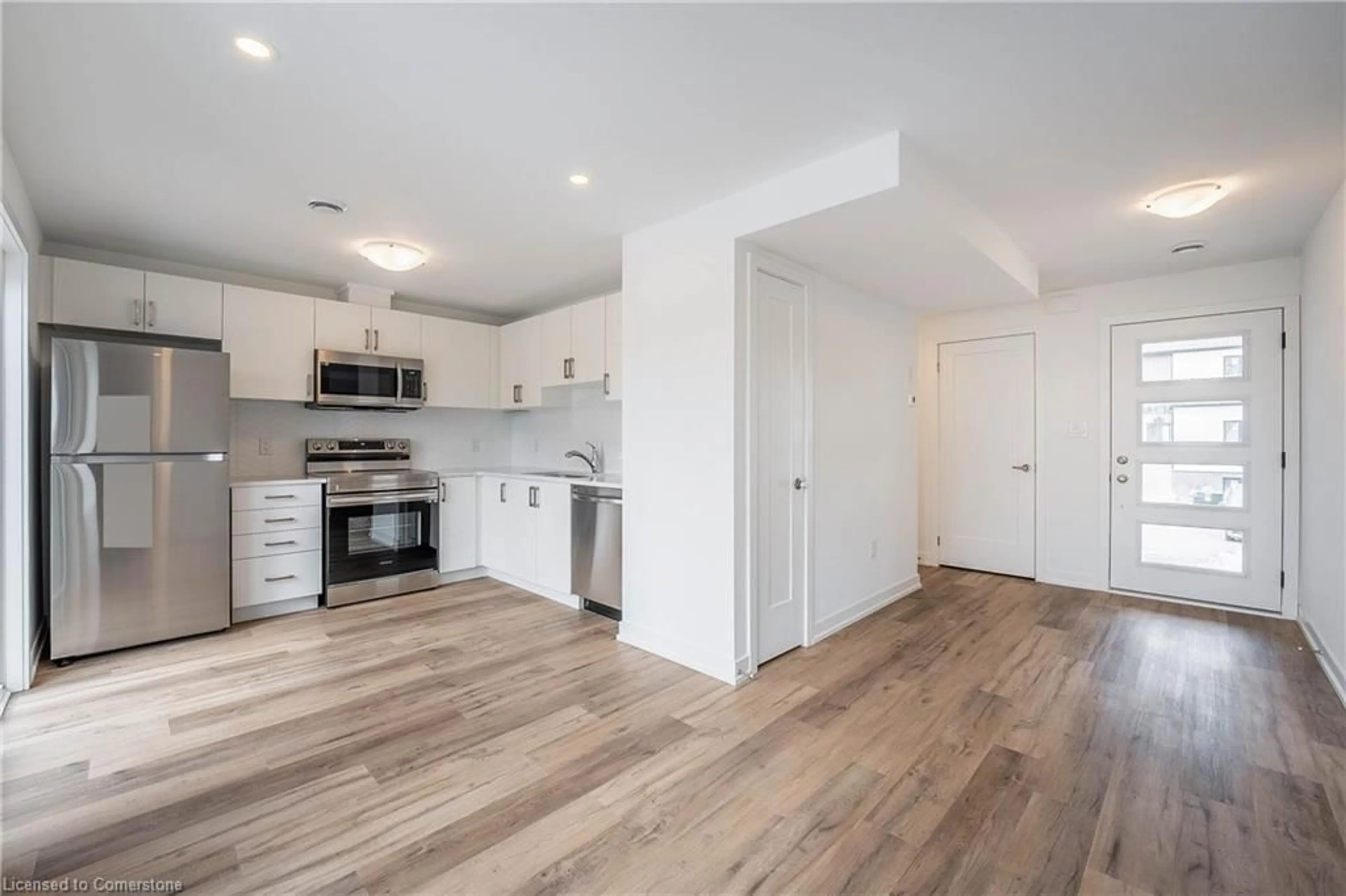 Open concept kitchen, wood/laminate floor for 4263 Fourth Ave #321, Niagara Falls Ontario L2E 0C2