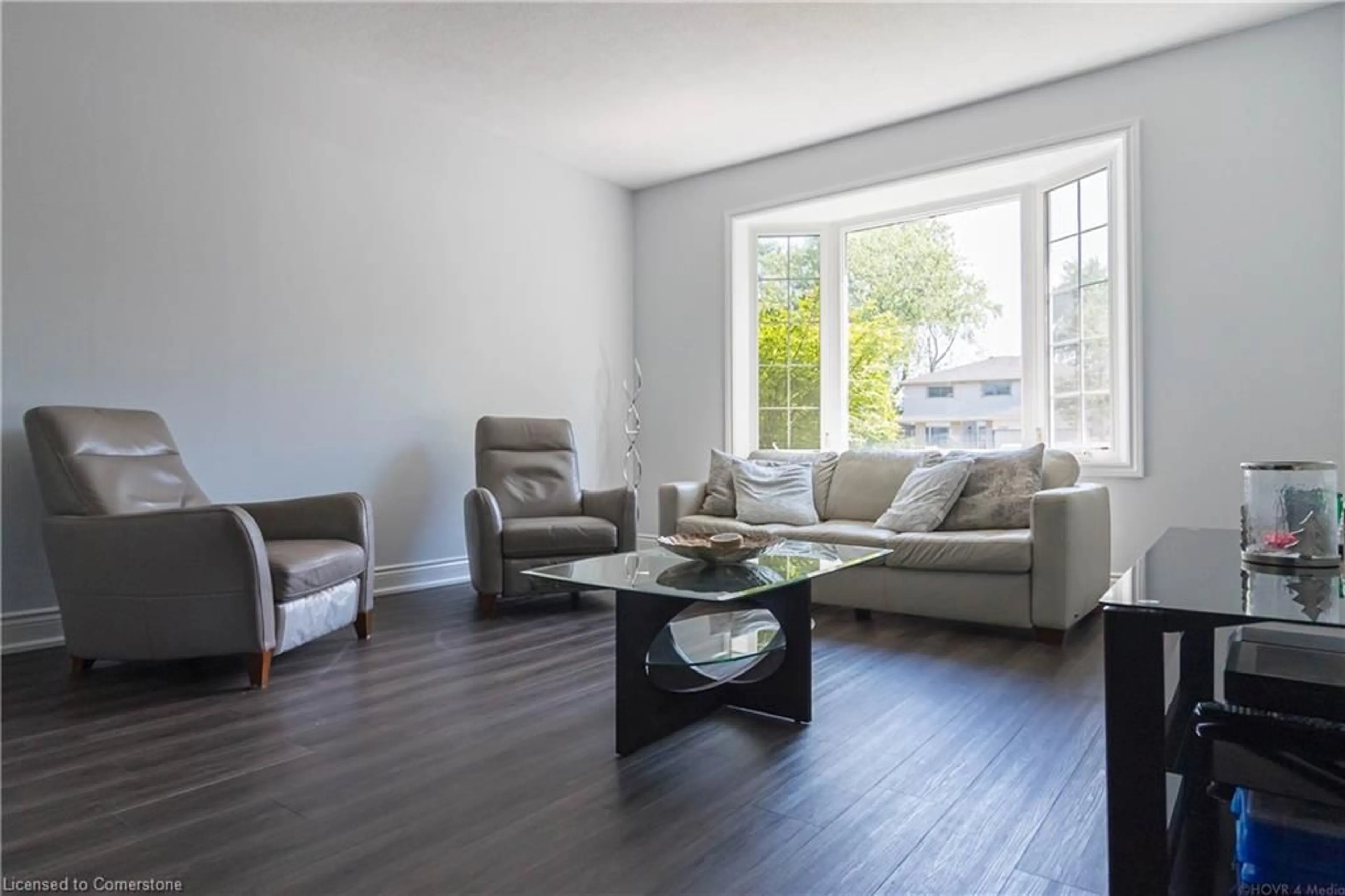 Living room with furniture, wood/laminate floor for 2390 Sinclair Cir, Burlington Ontario L7P 3C3