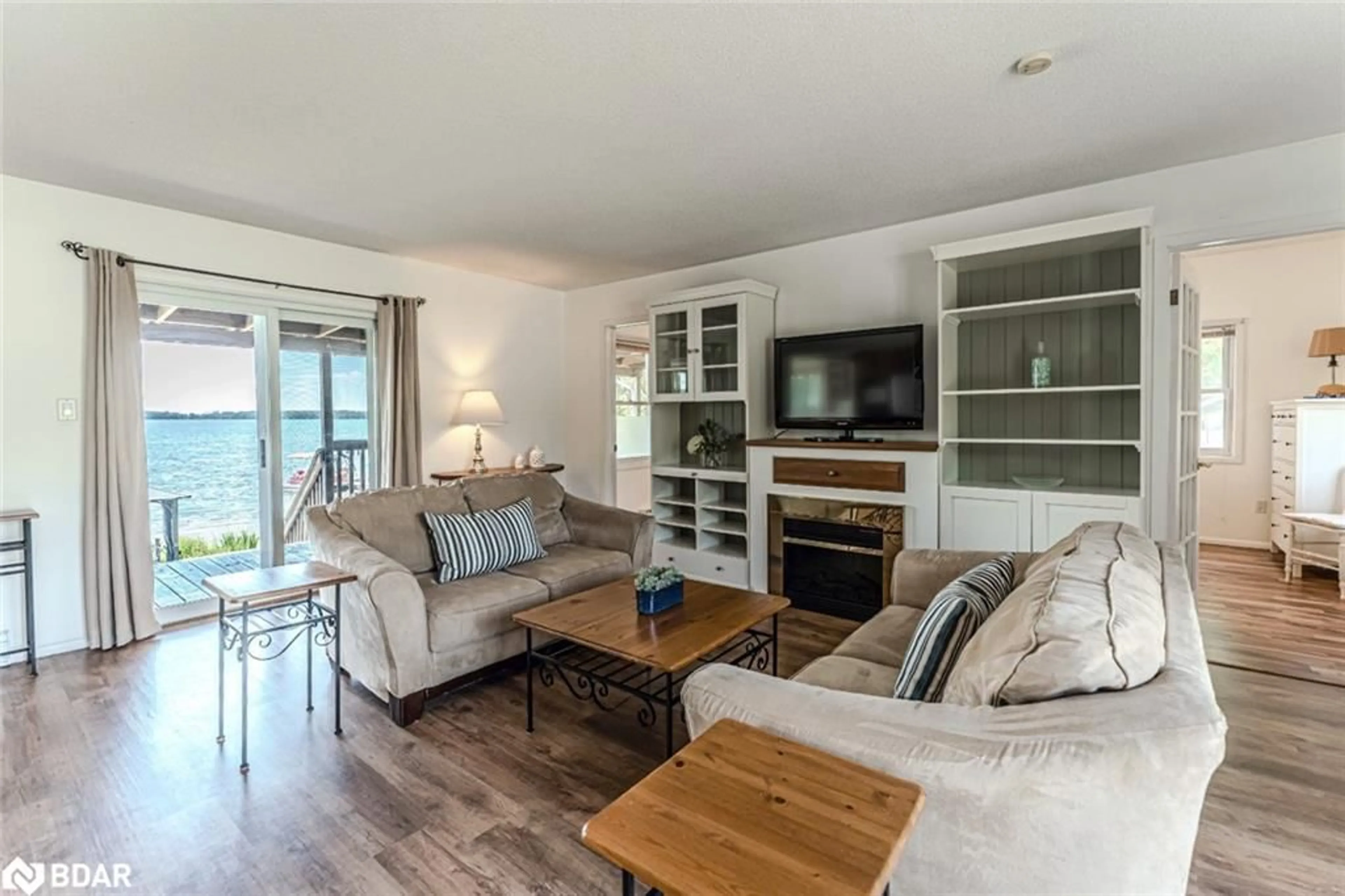 Living room with furniture, wood/laminate floor for 5580 Penetanguishene Rd, Elmvale Ontario L0L 1P0