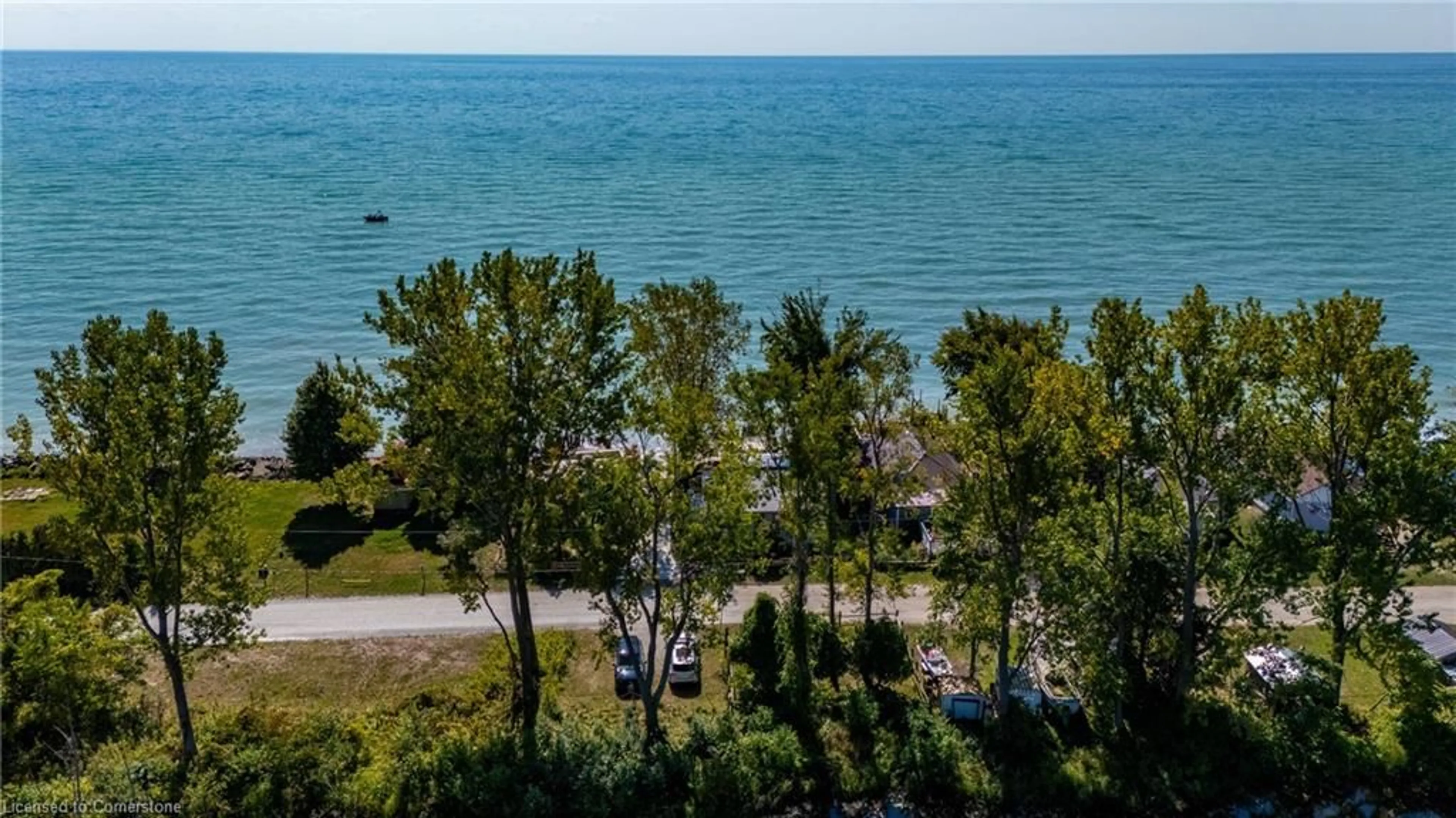 A pic from outside/outdoor area/front of a property/back of a property/a pic from drone, water/lake/river/ocean view for 203 Hastings Dr, Long Point Ontario N0E 1M0