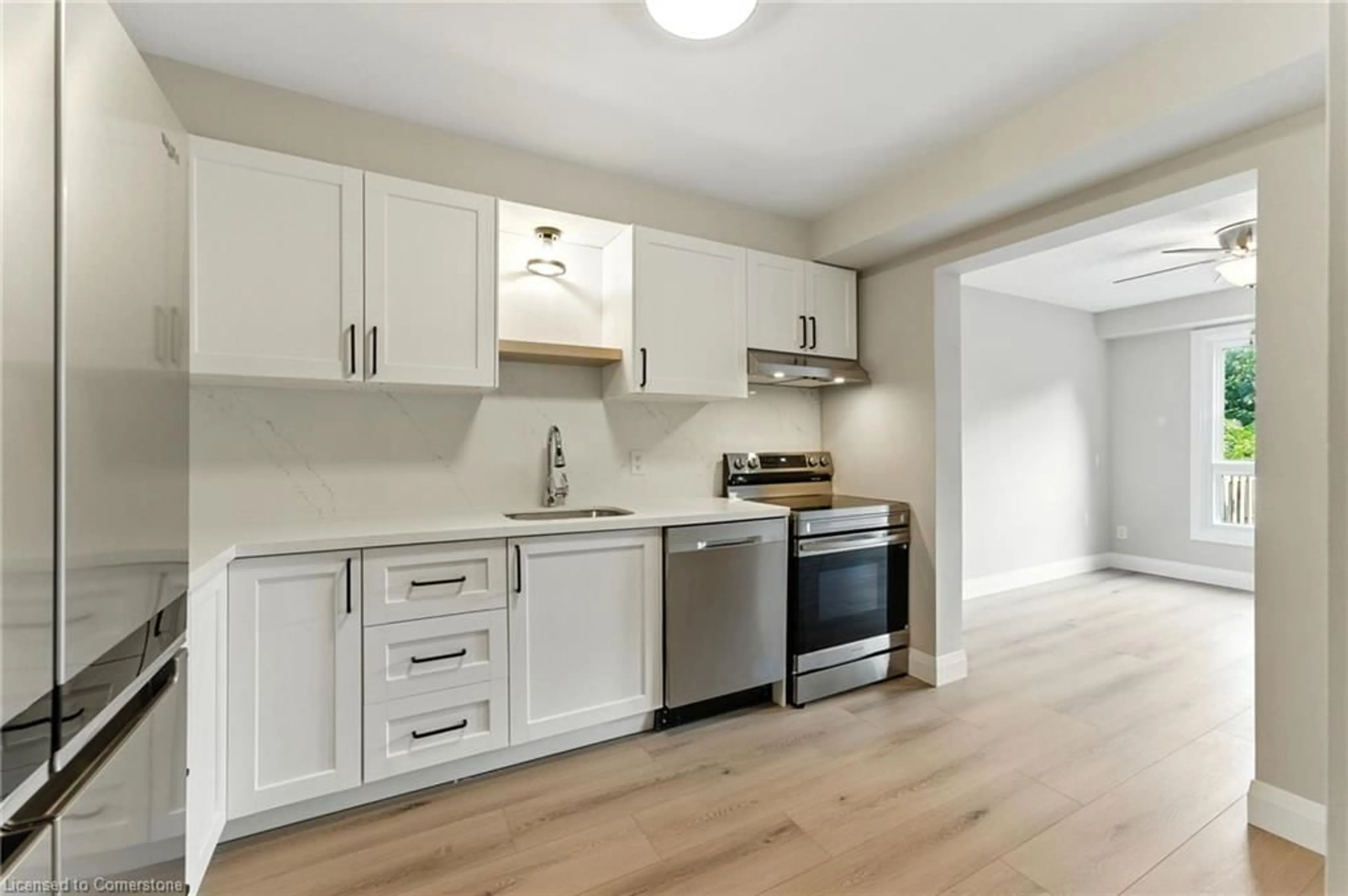 Open concept kitchen, wood/laminate floor for 131 Essling Ave, Hamilton Ontario L9B 2H9