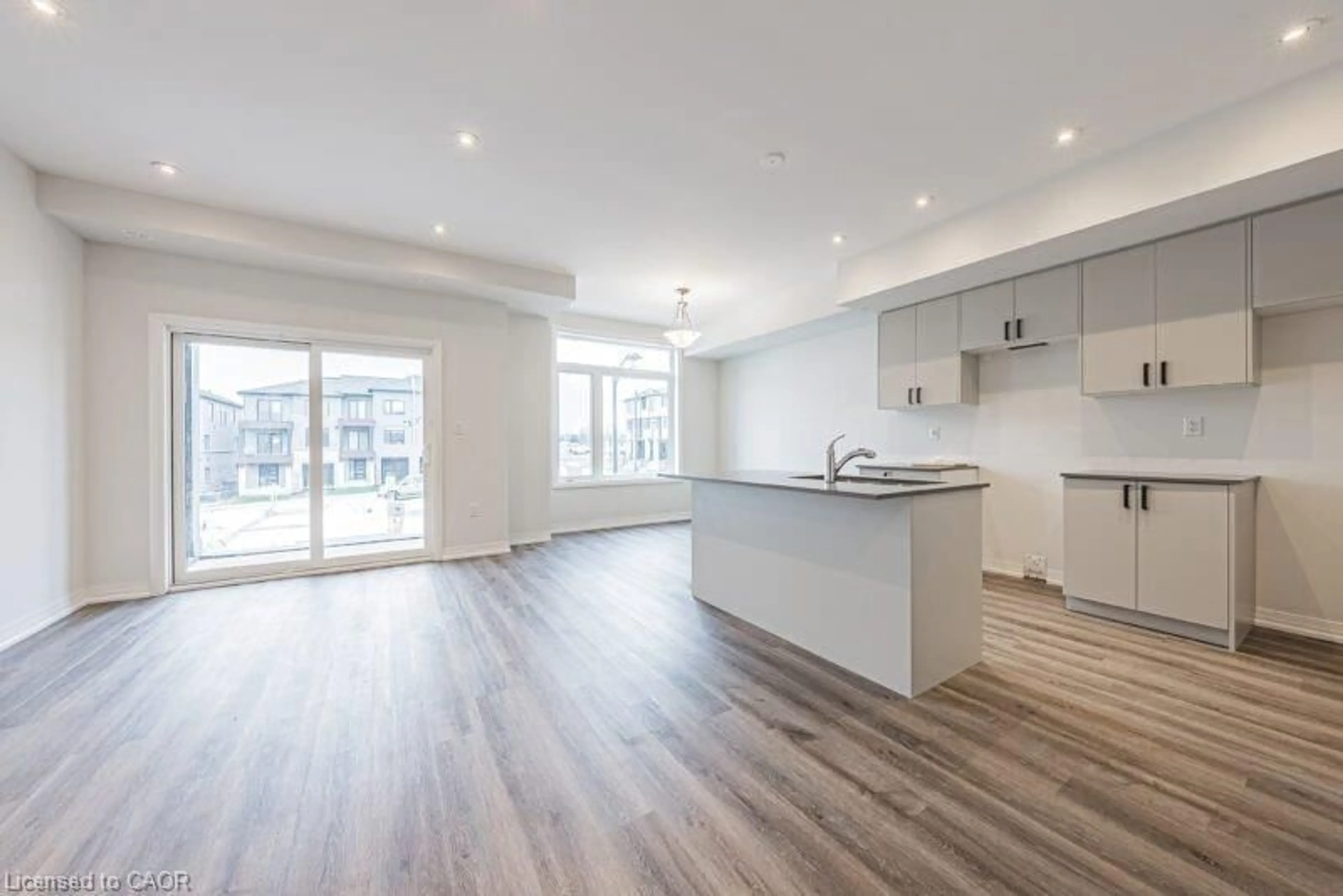Open concept kitchen, wood/laminate floor for 155 Equestrian Way #141, Cambridge Ontario N3E 0E8