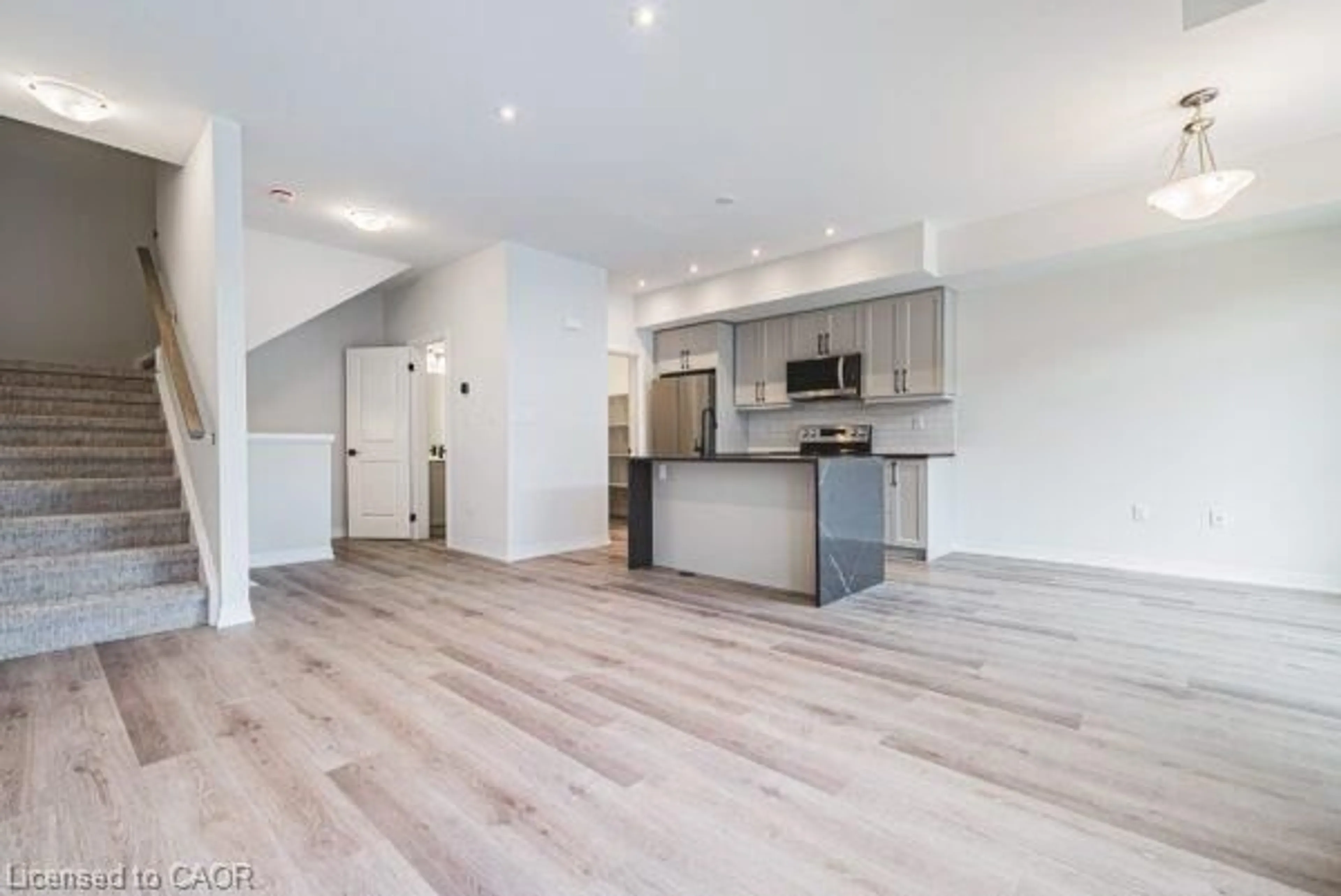 Open concept kitchen, wood/laminate floor for 155 Equestrian Way #131, Cambridge Ontario N3E 0E8
