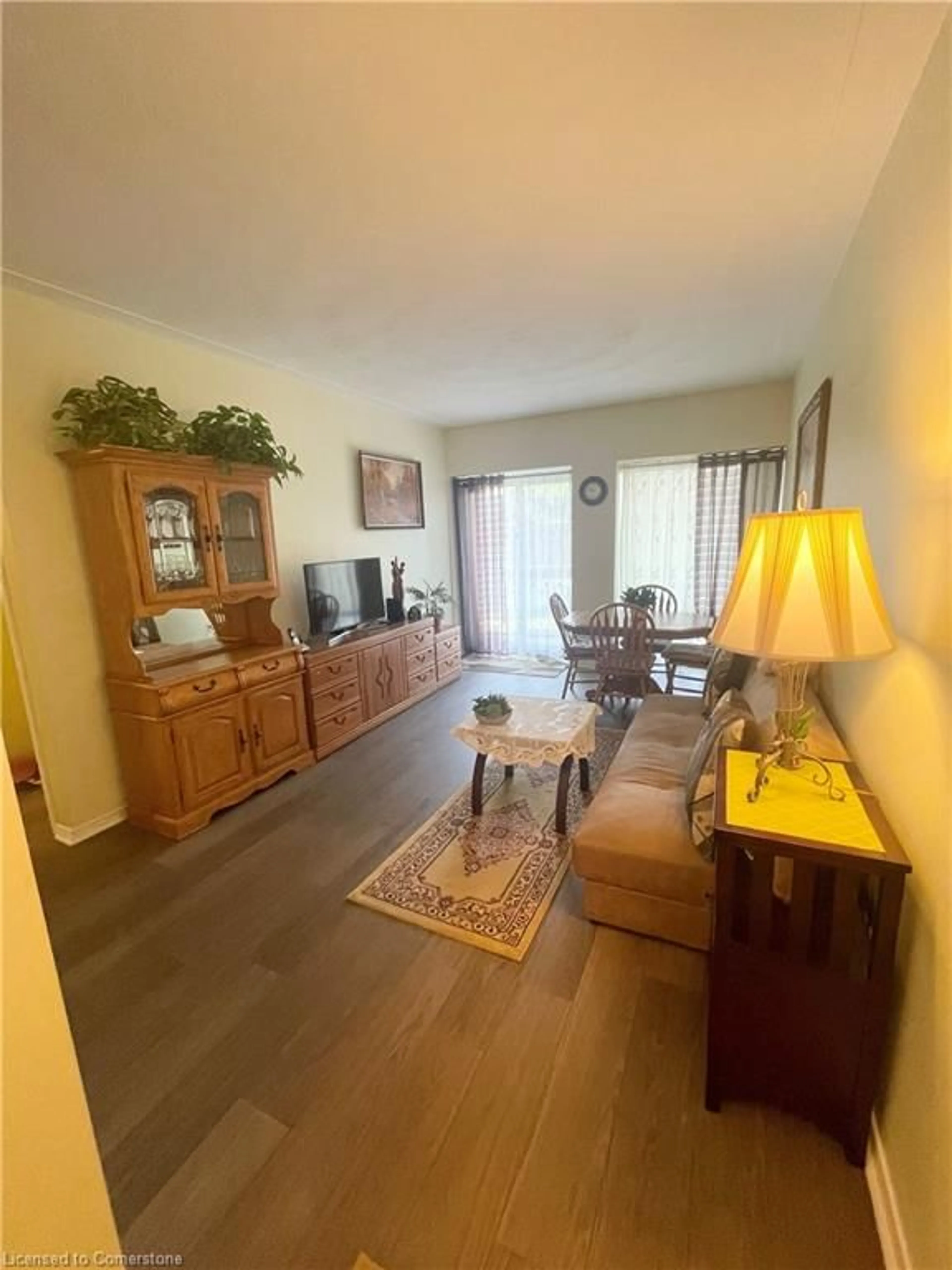 Living room with furniture, wood/laminate floor for 10 Woodman Dr #101, Hamilton Ontario L8K 4E1