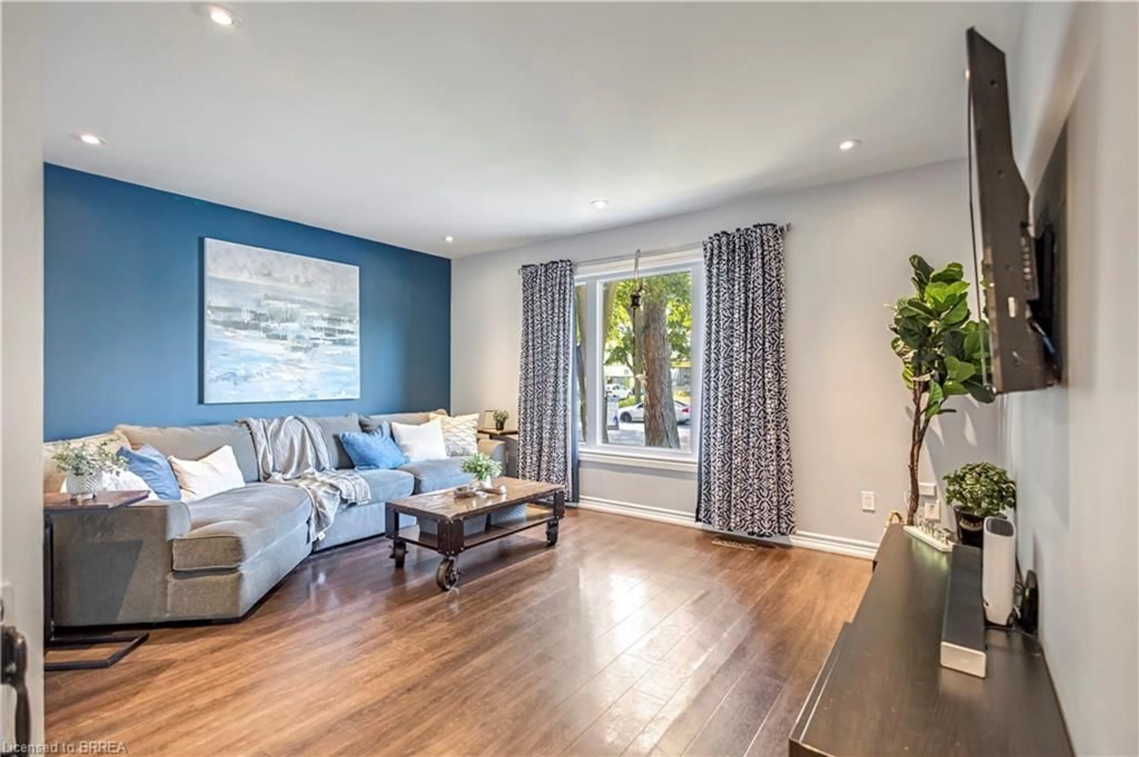 Living room with furniture, wood/laminate floor for 92 White Owl Cres, Brantford Ontario N3P 1A2
