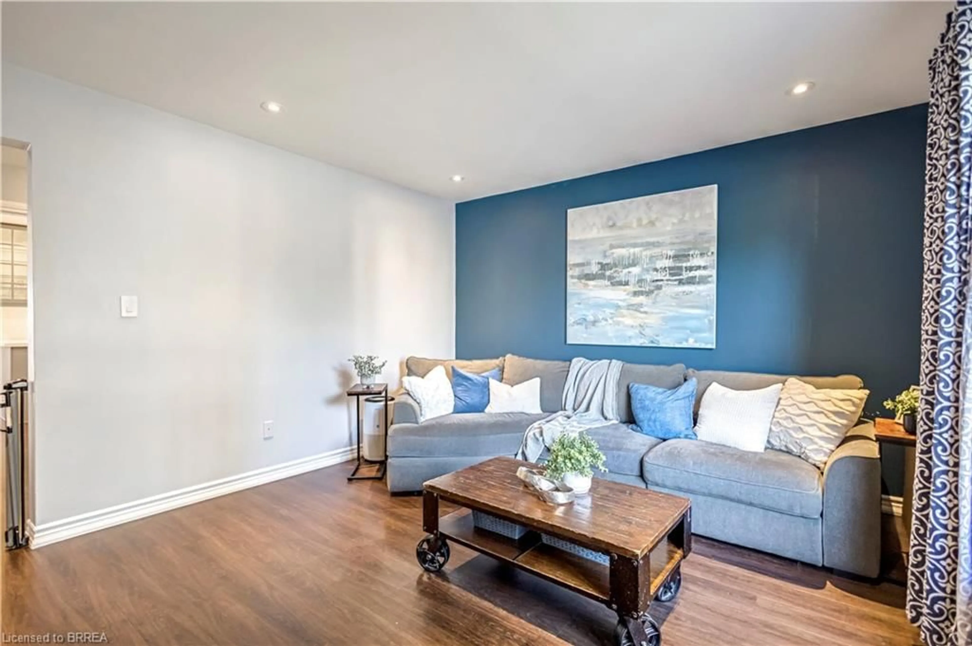 Living room with furniture, wood/laminate floor for 92 White Owl Cres, Brantford Ontario N3P 1A2