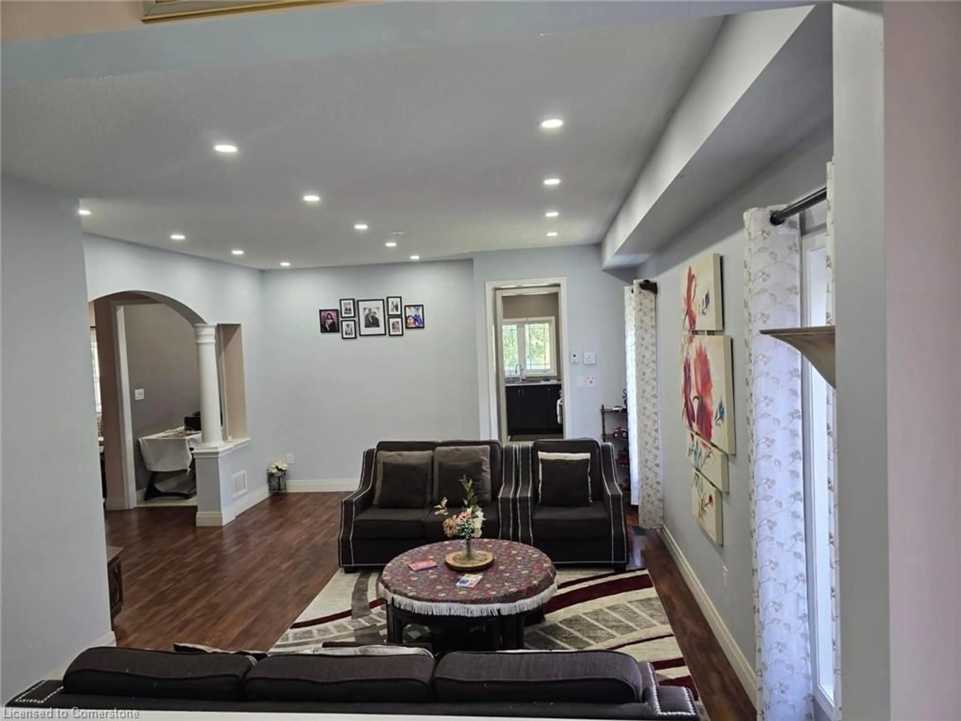Living room with furniture, wood/laminate floor for 261 Thomas Ave, Brantford Ontario N3S 0E1
