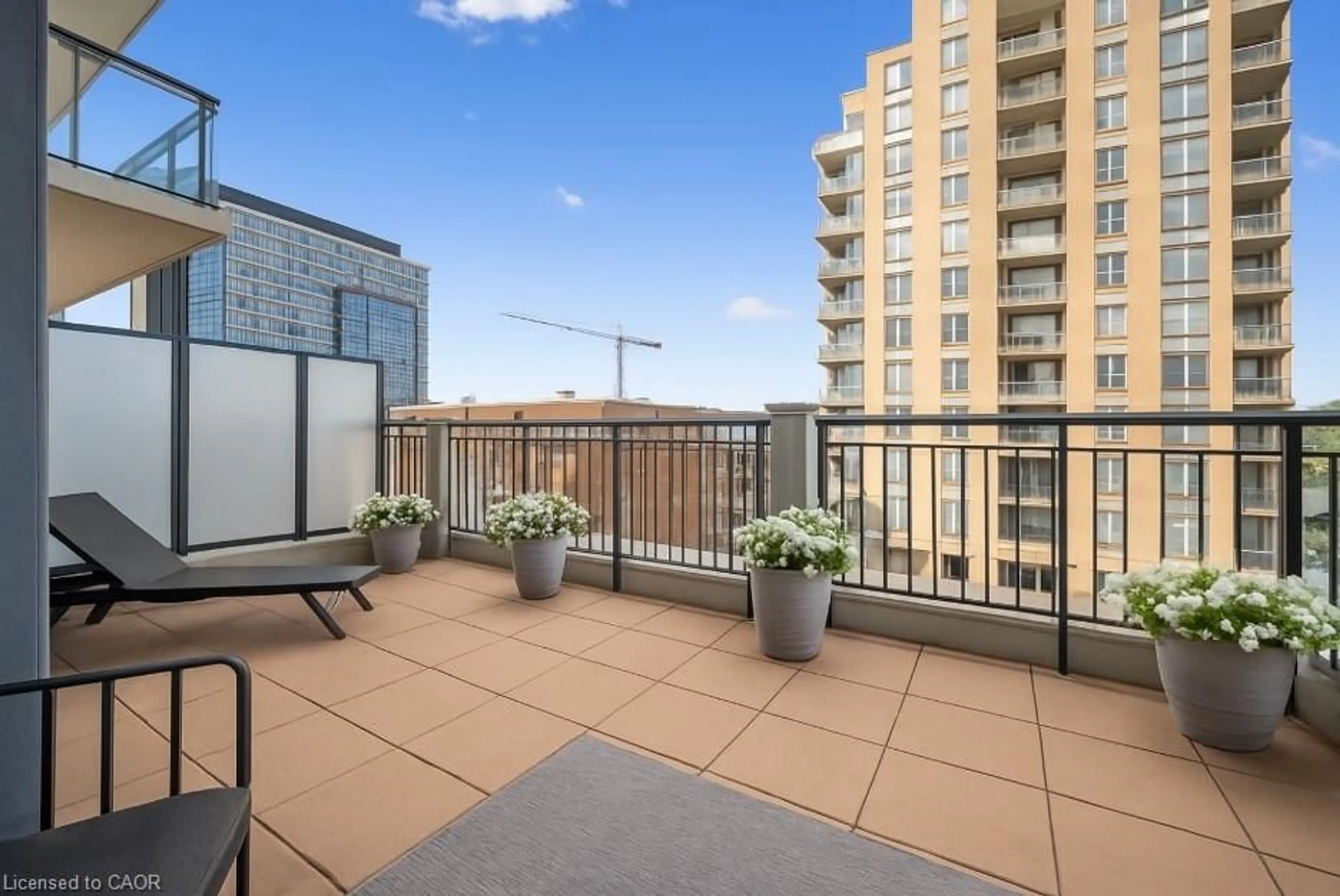 Patio, city buildings view from balcony for 155 Caroline St #403, Waterloo Ontario N2L 0J8