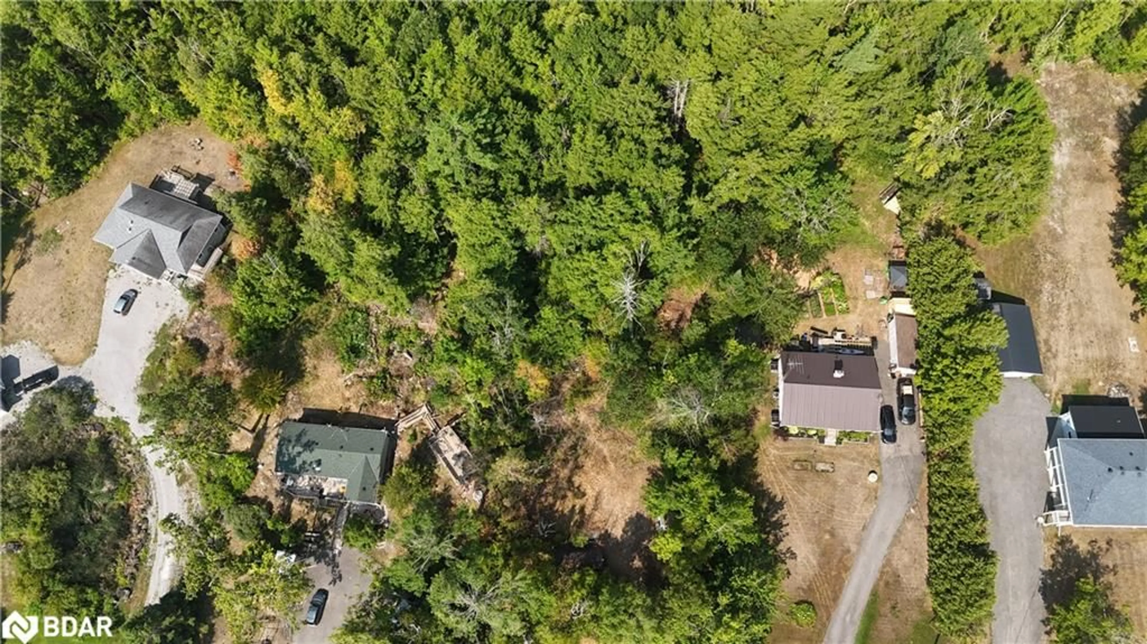 A pic from outside/outdoor area/front of a property/back of a property/a pic from drone, forest/trees view for 400 Kennedy Dr, Bobcaygeon Ontario K0M 1A0