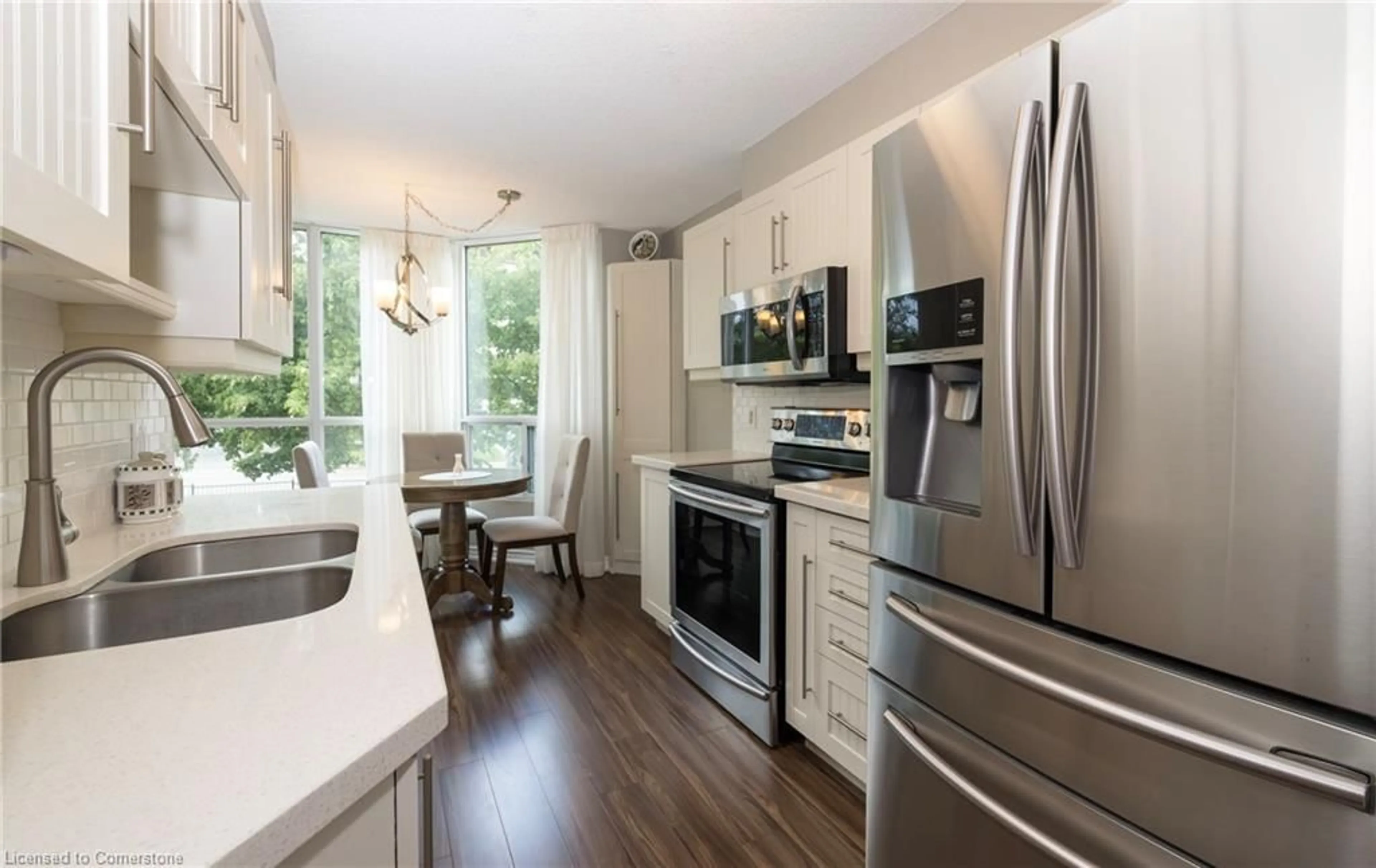 Open concept kitchen, wood/laminate floor for 100 Millside Dr #206, Milton Ontario L9T 5E2