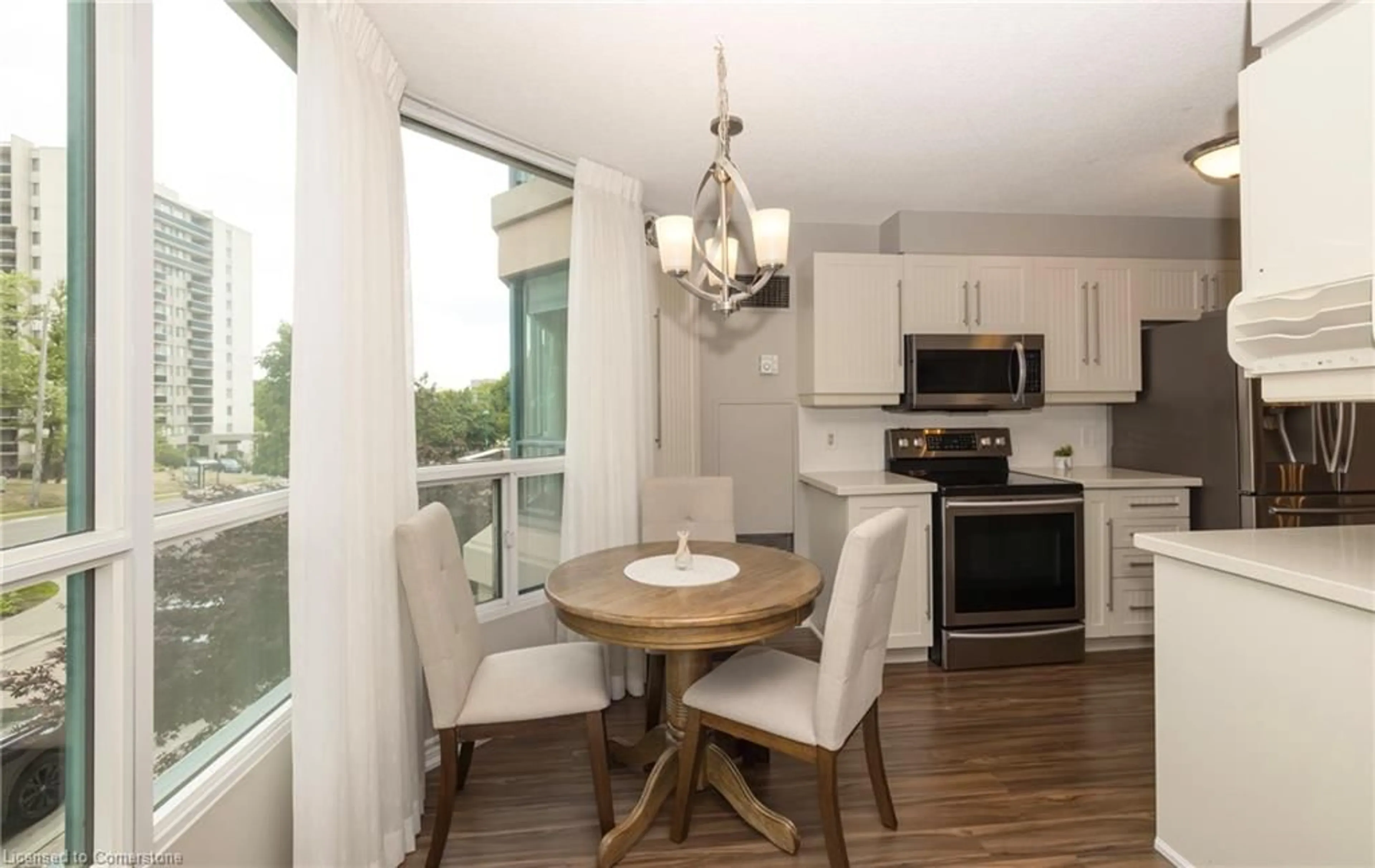 Open concept kitchen, wood/laminate floor for 100 Millside Dr #206, Milton Ontario L9T 5E2