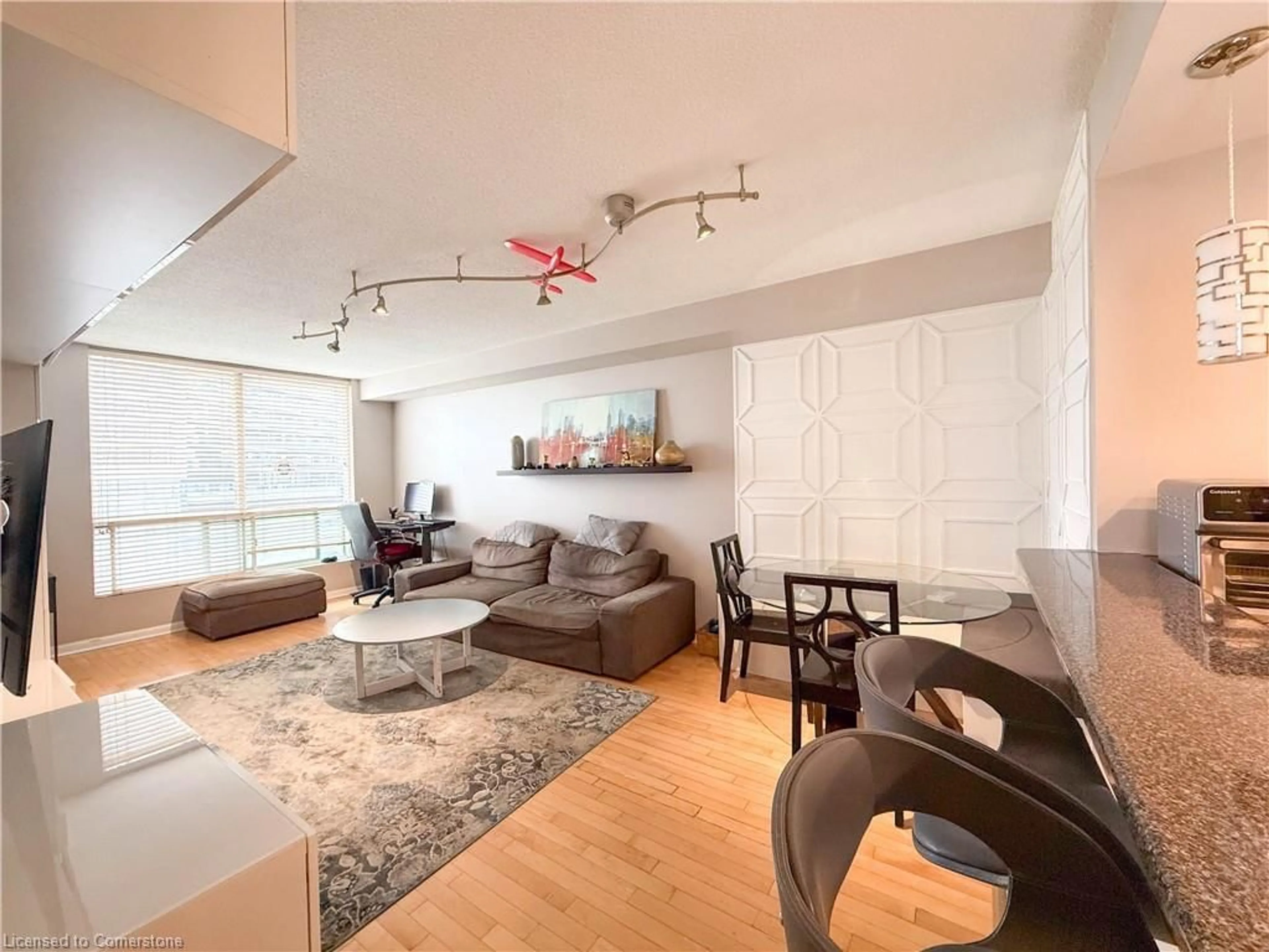 Living room with furniture, wood/laminate floor for 101 Subway Cres #712, Toronto Ontario M9B 6K4