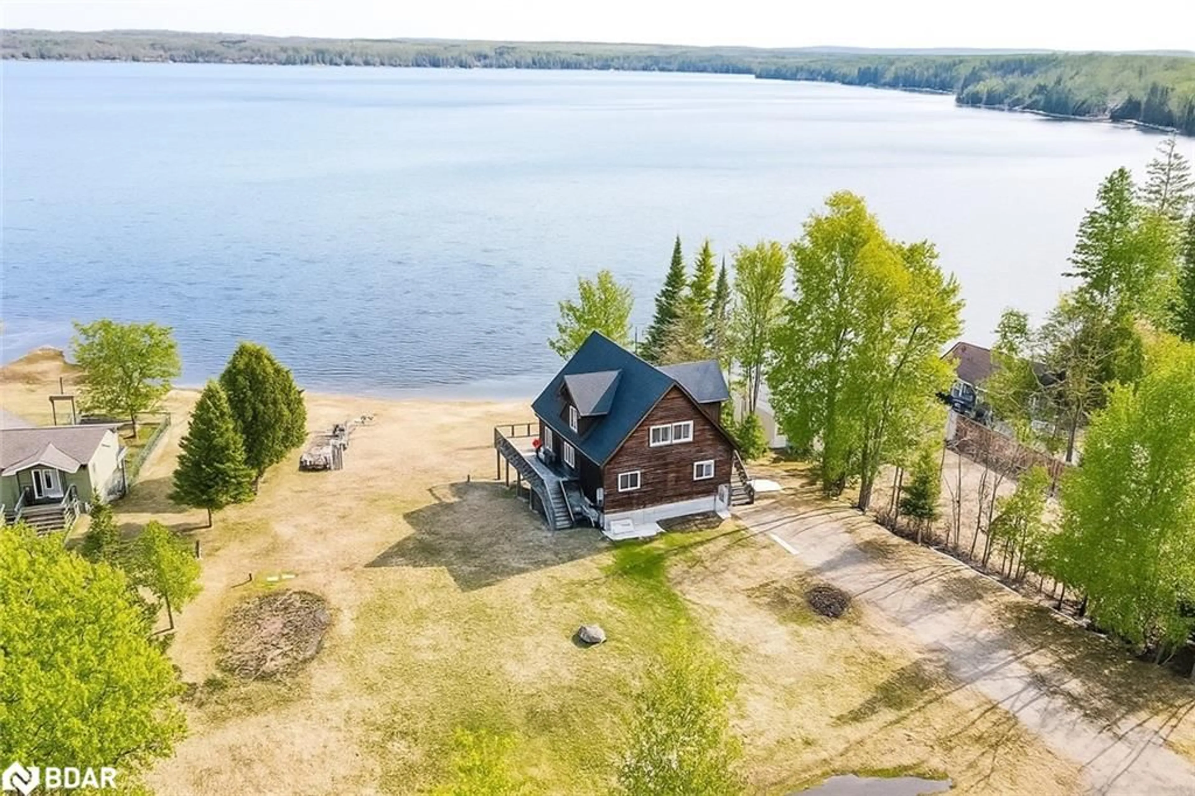A pic from outside/outdoor area/front of a property/back of a property/a pic from drone, water/lake/river/ocean view for 3093 Sandy Bend Rd, Elmvale Ontario L0L 1P0