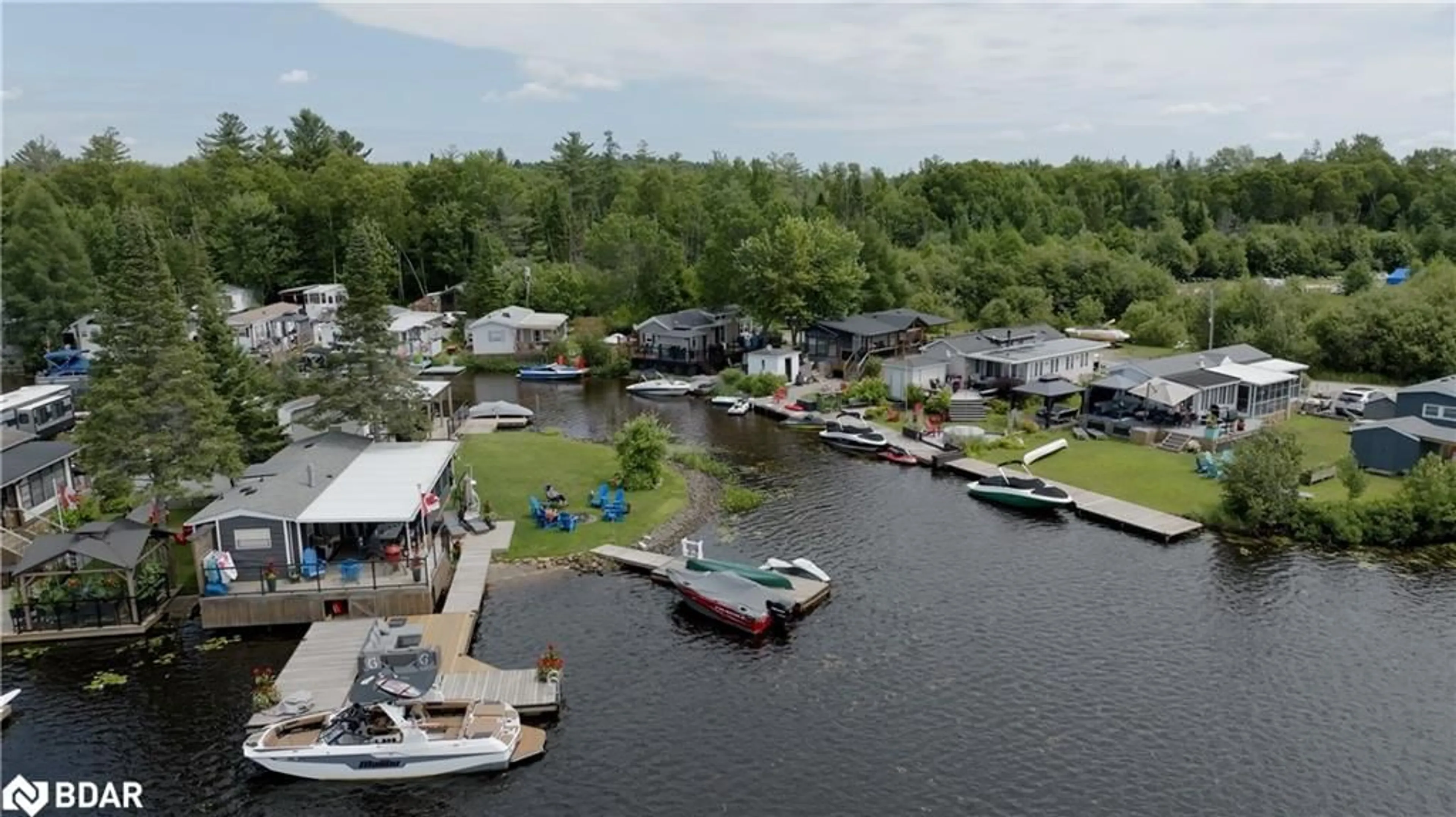 A pic from outside/outdoor area/front of a property/back of a property/a pic from drone, water/lake/river/ocean view for 85 Hutchinson Beach Rd #B56, Huntsville Ontario P1H 1N4