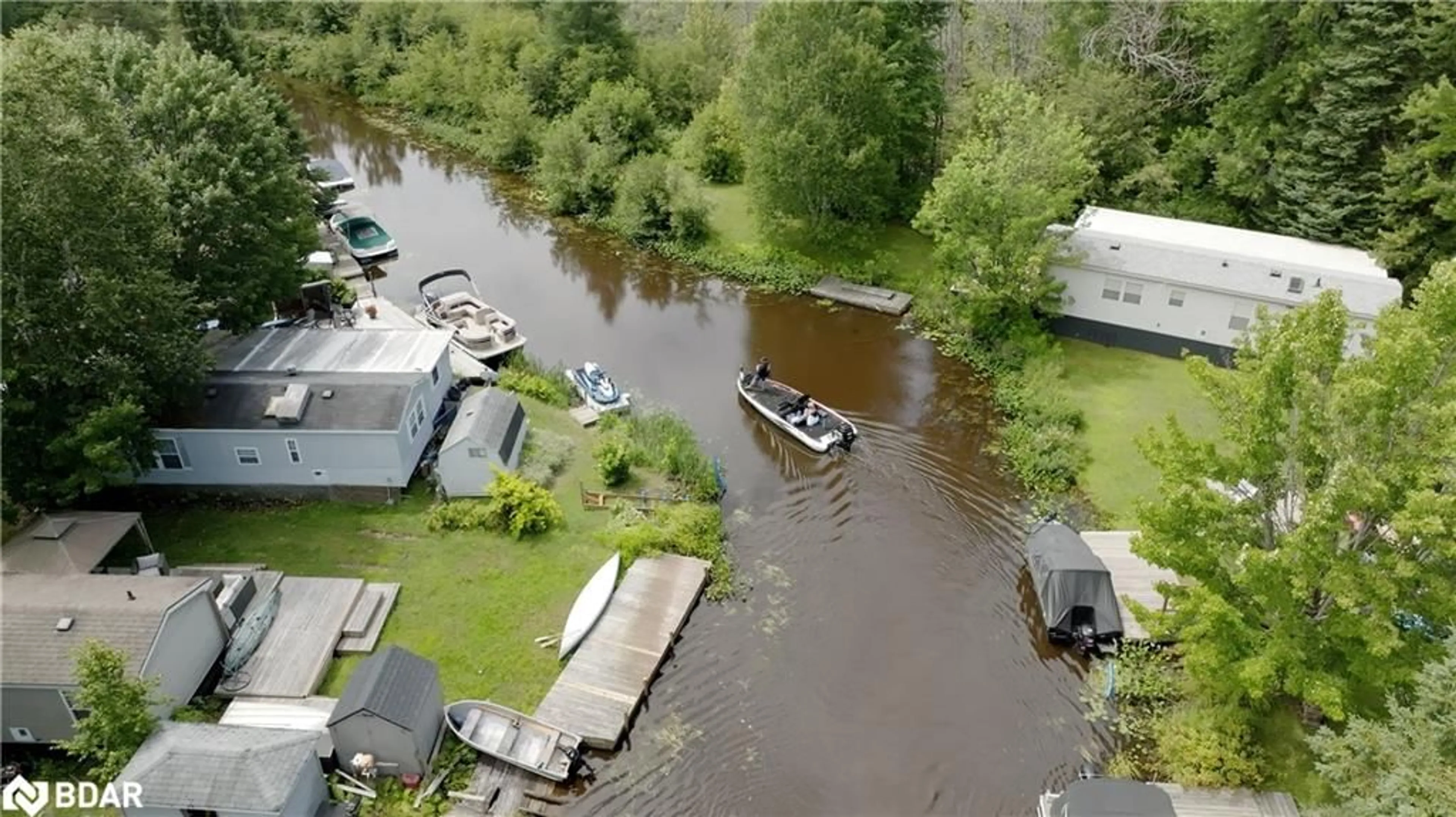 A pic from outside/outdoor area/front of a property/back of a property/a pic from drone, water/lake/river/ocean view for 85 Hutchinson Beach Rd #B56, Huntsville Ontario P1H 1N4