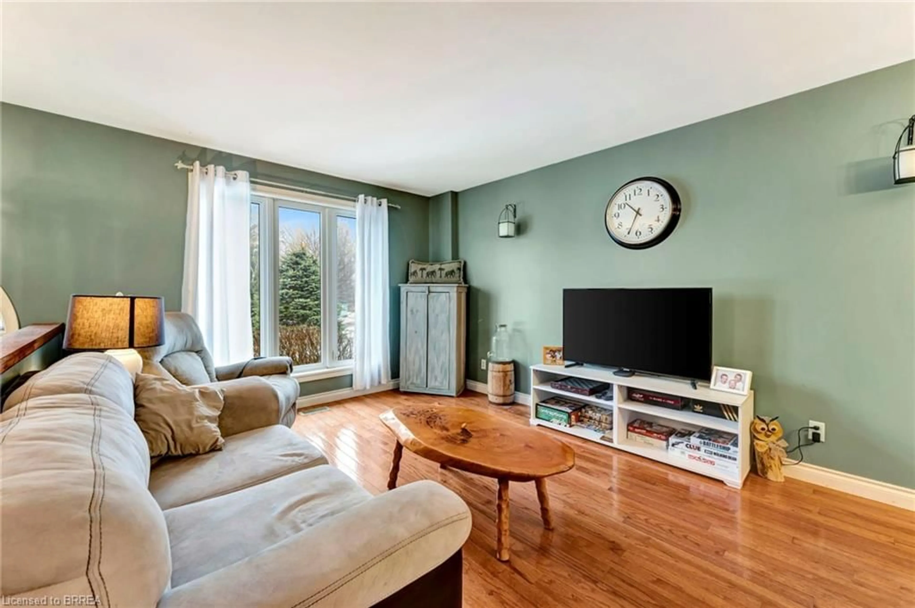 Living room with furniture, wood/laminate floor for 901 Windham 11 Rd, Delhi Ontario N4B 2W5
