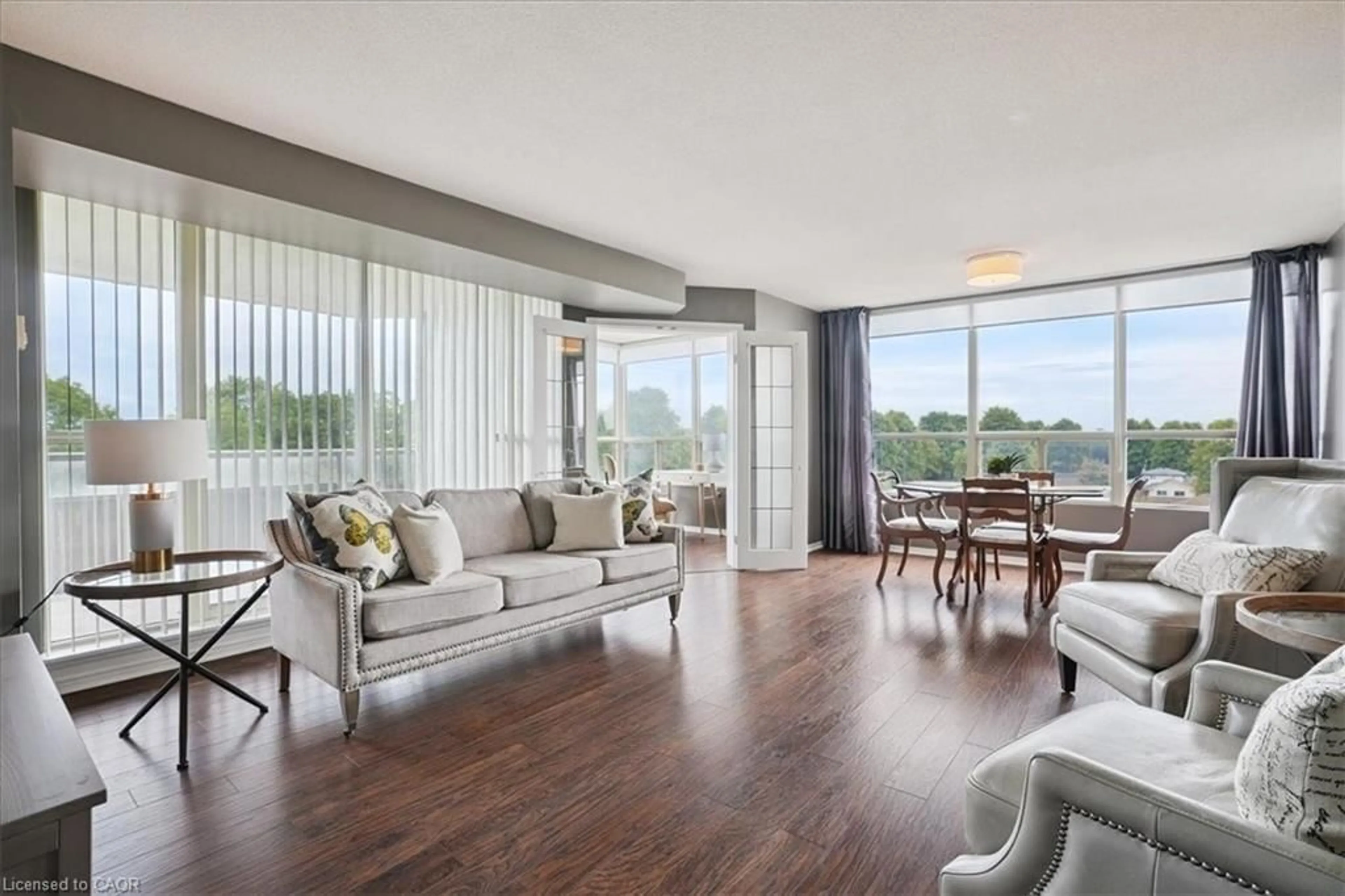 Living room with furniture, wood/laminate floor for 5100 Dorchester Rd #608, Niagara Falls Ontario L2E 7H4