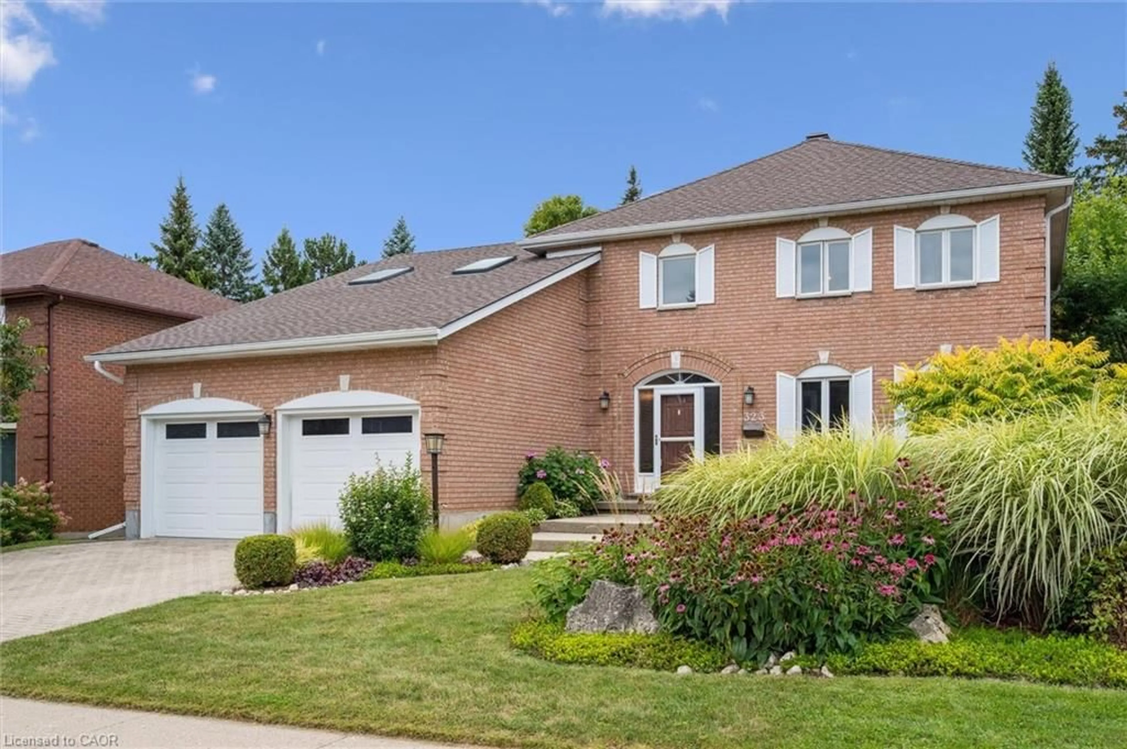 Home with brick exterior material, street for 323 Amberwood Dr, Waterloo Ontario N2T 2E9
