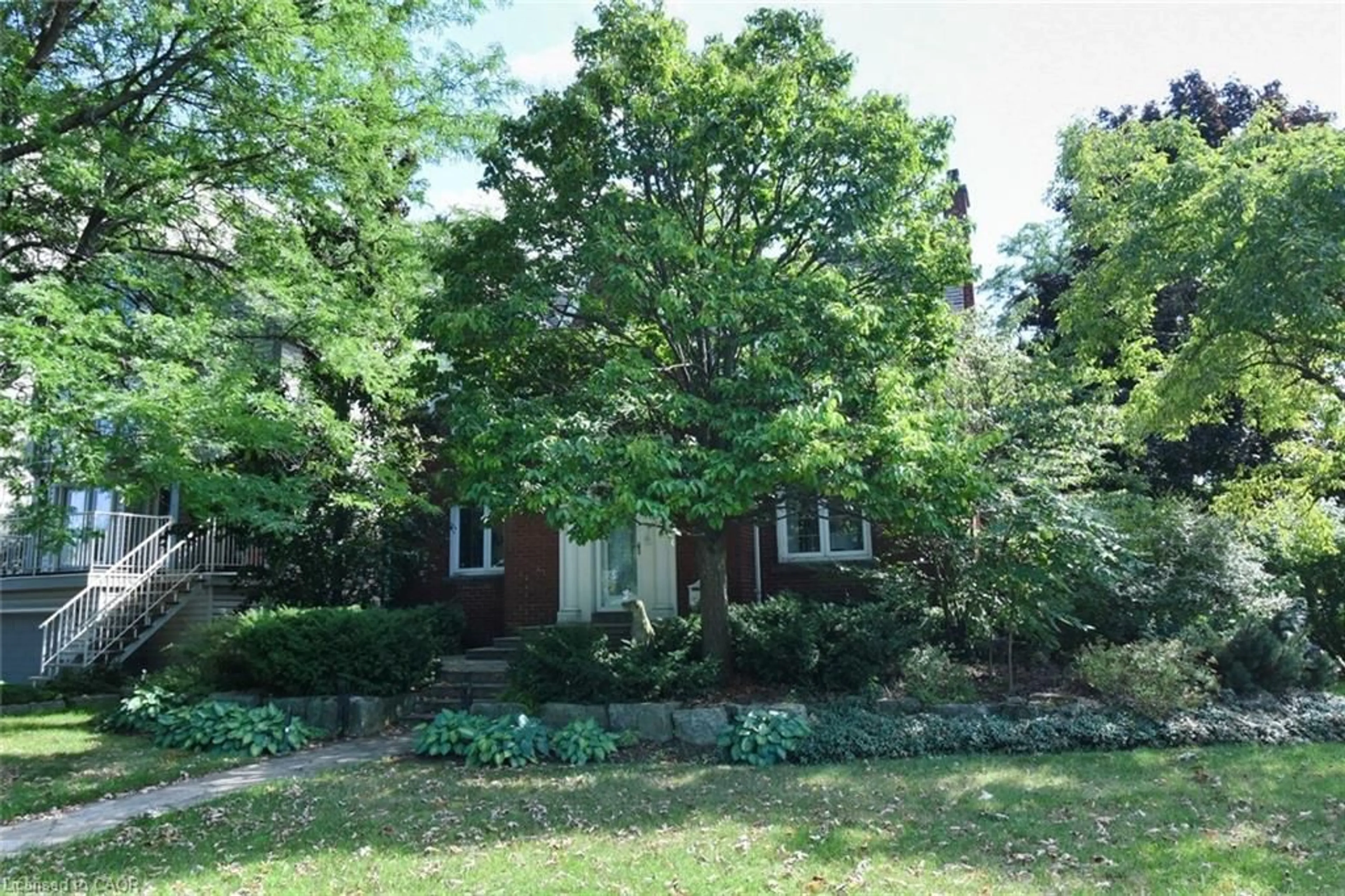 Home with brick exterior material, forest/trees view for 200 Concession St, Hamilton Ontario L9A 1A9